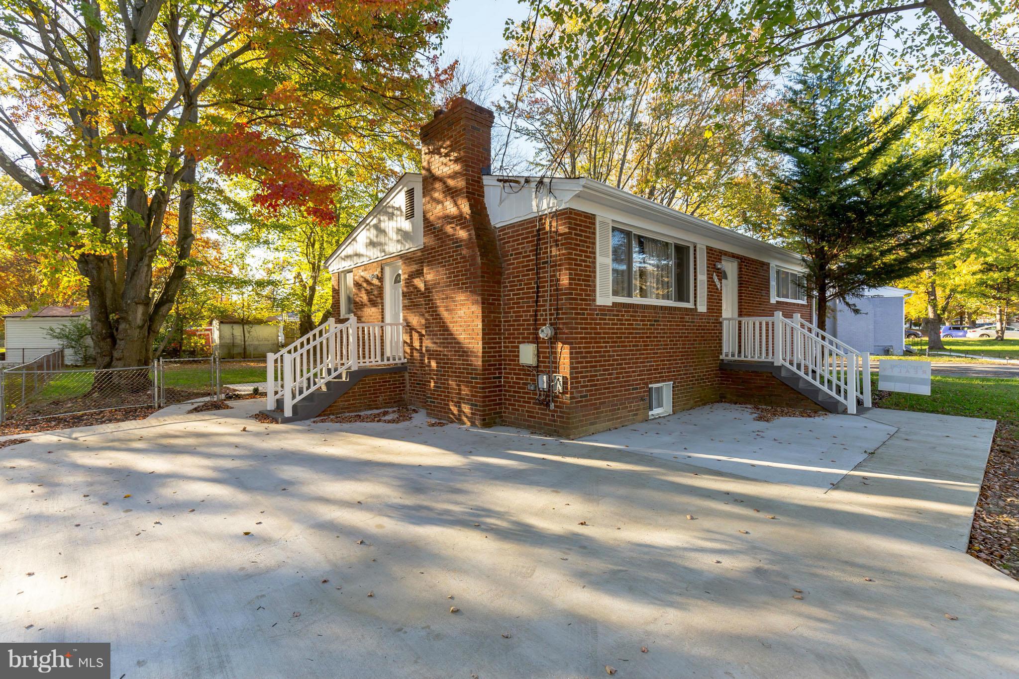 8303 Allentown Road Fort Washington, MD 20744 - Photo 2 of 30 a front view of a house with a yard and garage
