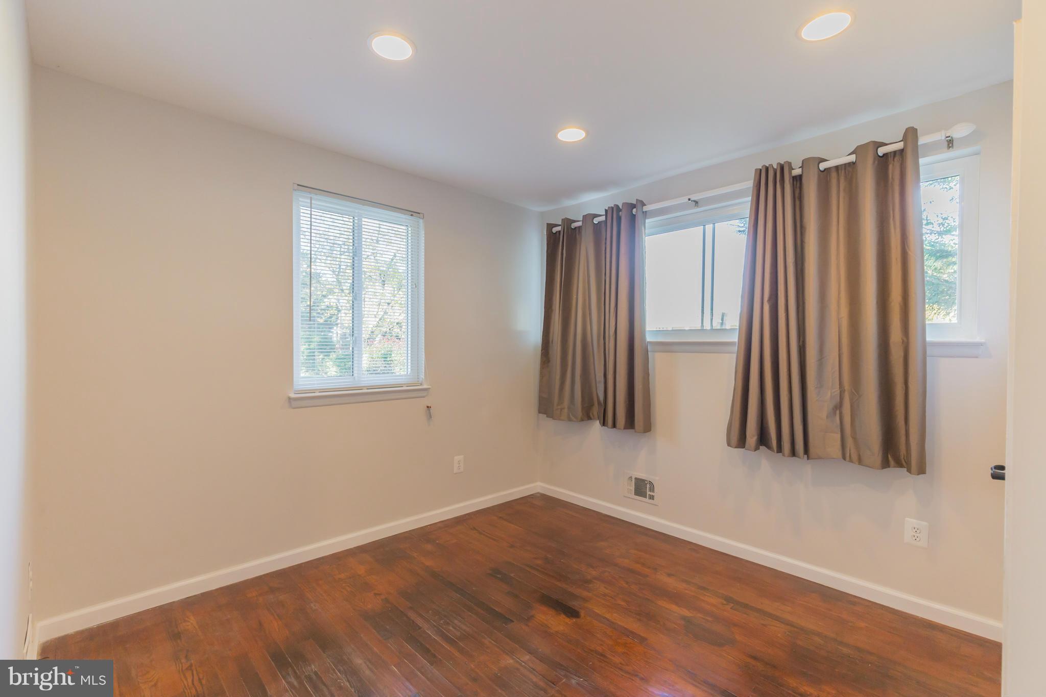 8303 Allentown Road Fort Washington, MD 20744 - Photo 14 of 30 wooden floor in an empty room with a window