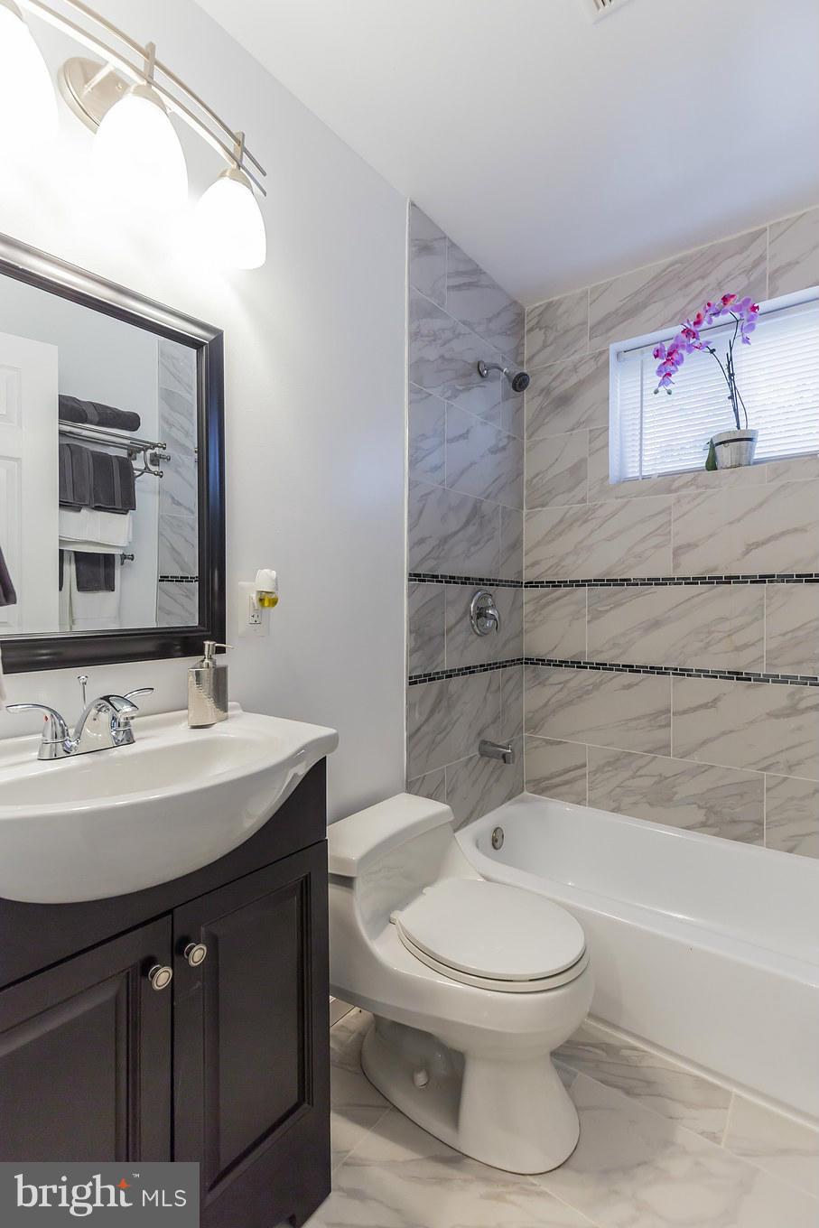 8303 Allentown Road Fort Washington, MD 20744 - Photo 16 of 30 a bathroom with a sink a toilet and shower