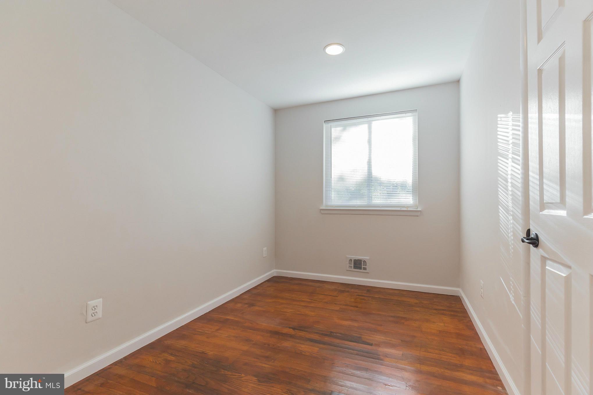 8303 Allentown Road Fort Washington, MD 20744 - Photo 17 of 30 an empty room with wooden floor and windows