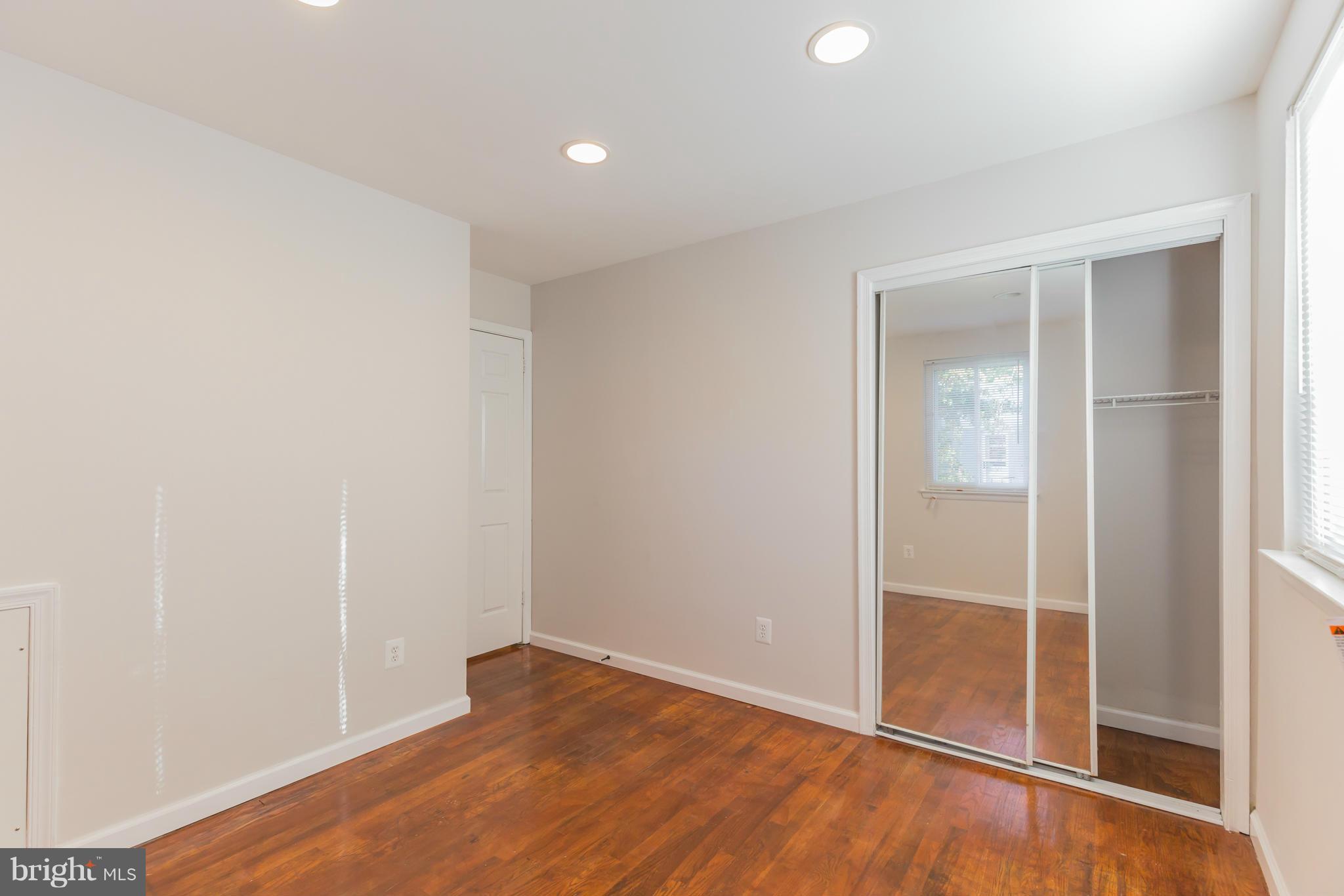 8303 Allentown Road Fort Washington, MD 20744 - Photo 20 of 30 an empty room with wooden floor and door