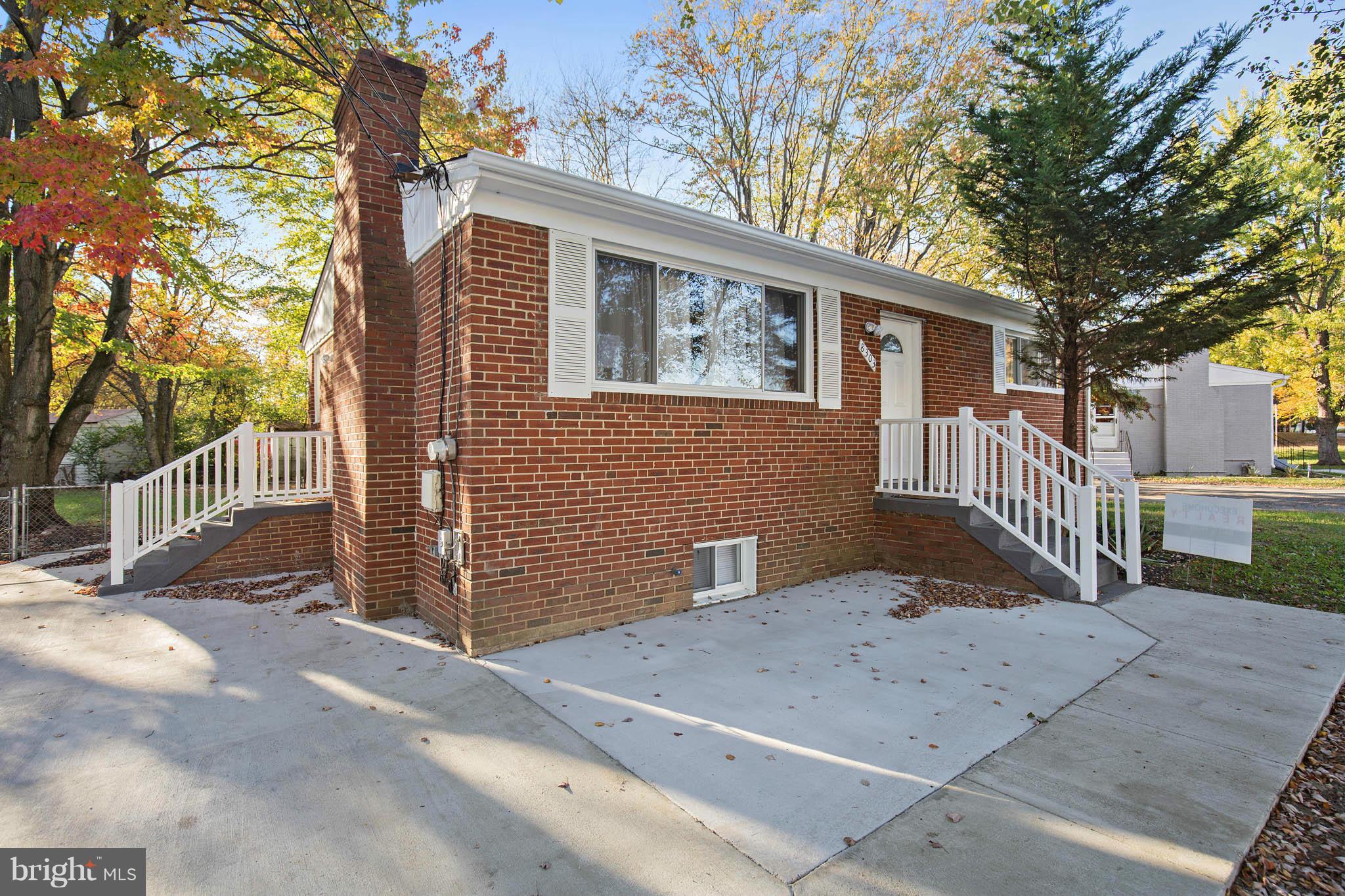 8303 Allentown Road Fort Washington, MD 20744 - Photo 3 of 30 a front view of a house with a yard