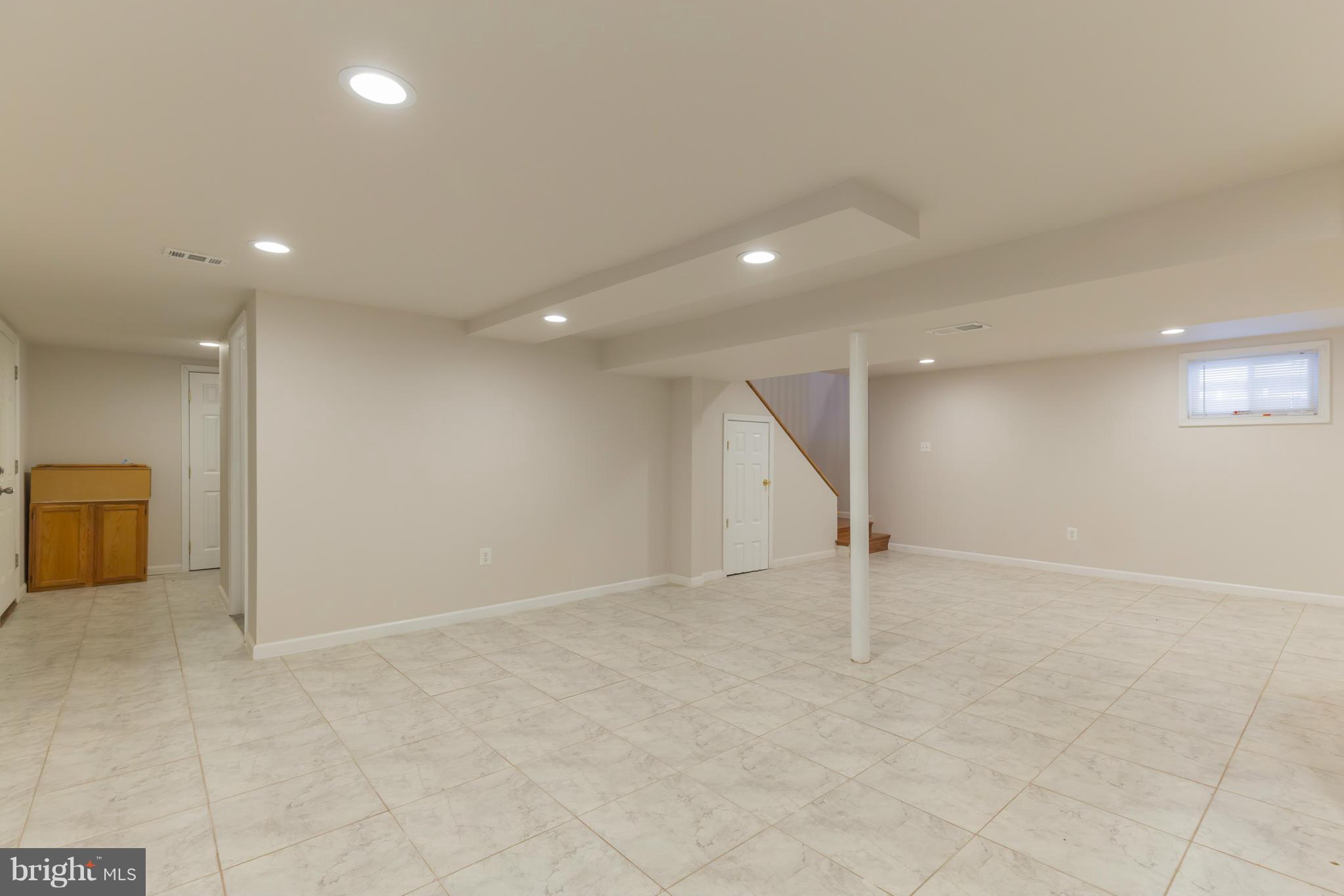 8303 Allentown Road Fort Washington, MD 20744 - Photo 24 of 30 an empty room with wooden floor and natural light
