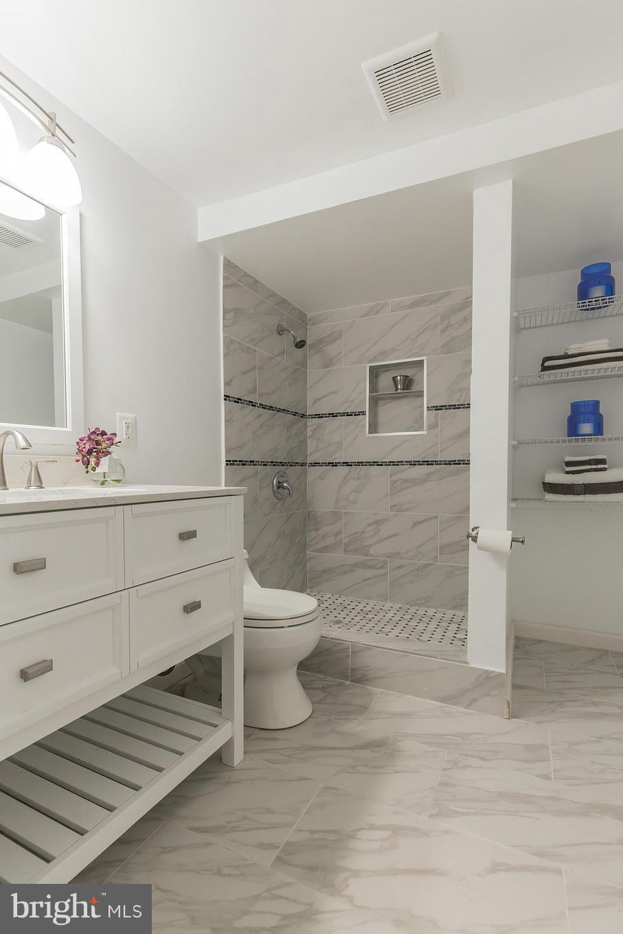 8303 Allentown Road Fort Washington, MD 20744 - Photo 25 of 30 a bathroom with a sink toilet and mirror