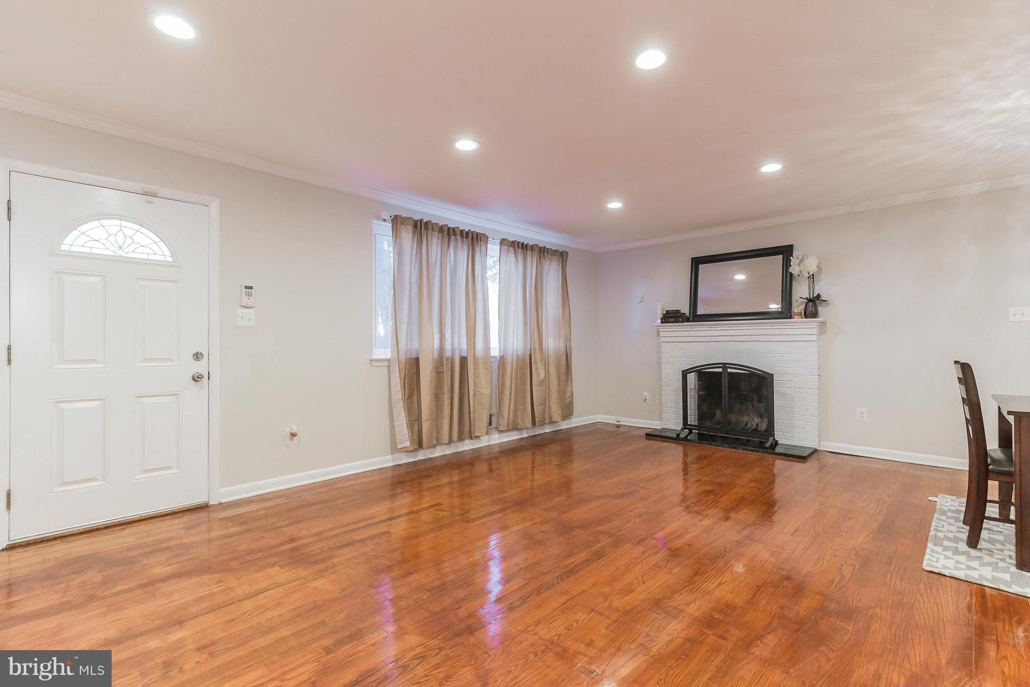 8303 Allentown Road Fort Washington, MD 20744 - Photo 4 of 30 a view of empty room with wooden floor and fireplace