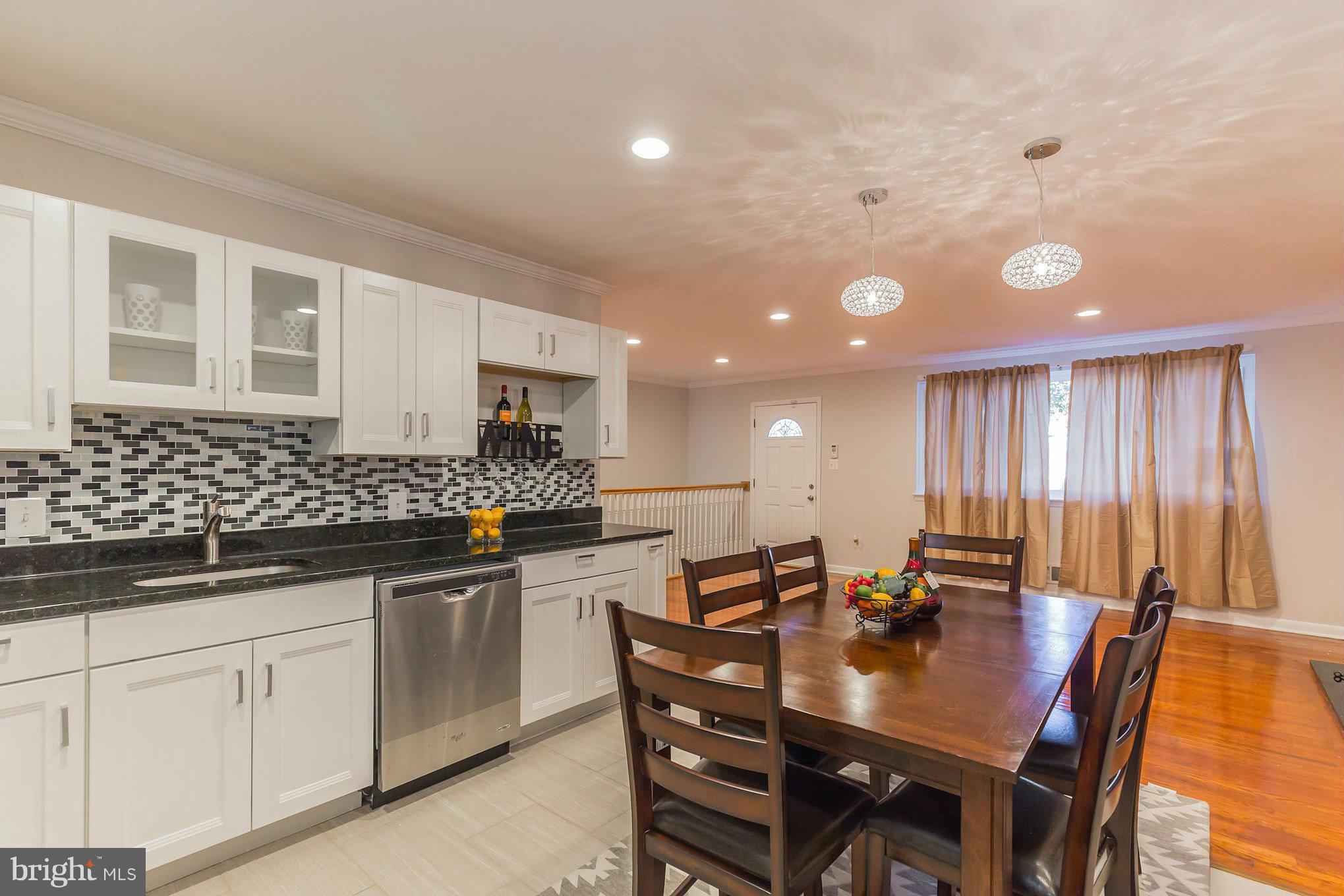 8303 Allentown Road Fort Washington, MD 20744 - Photo 8 of 30 a kitchen with stainless steel appliances granite countertop a sink a stove a dining table and chairs