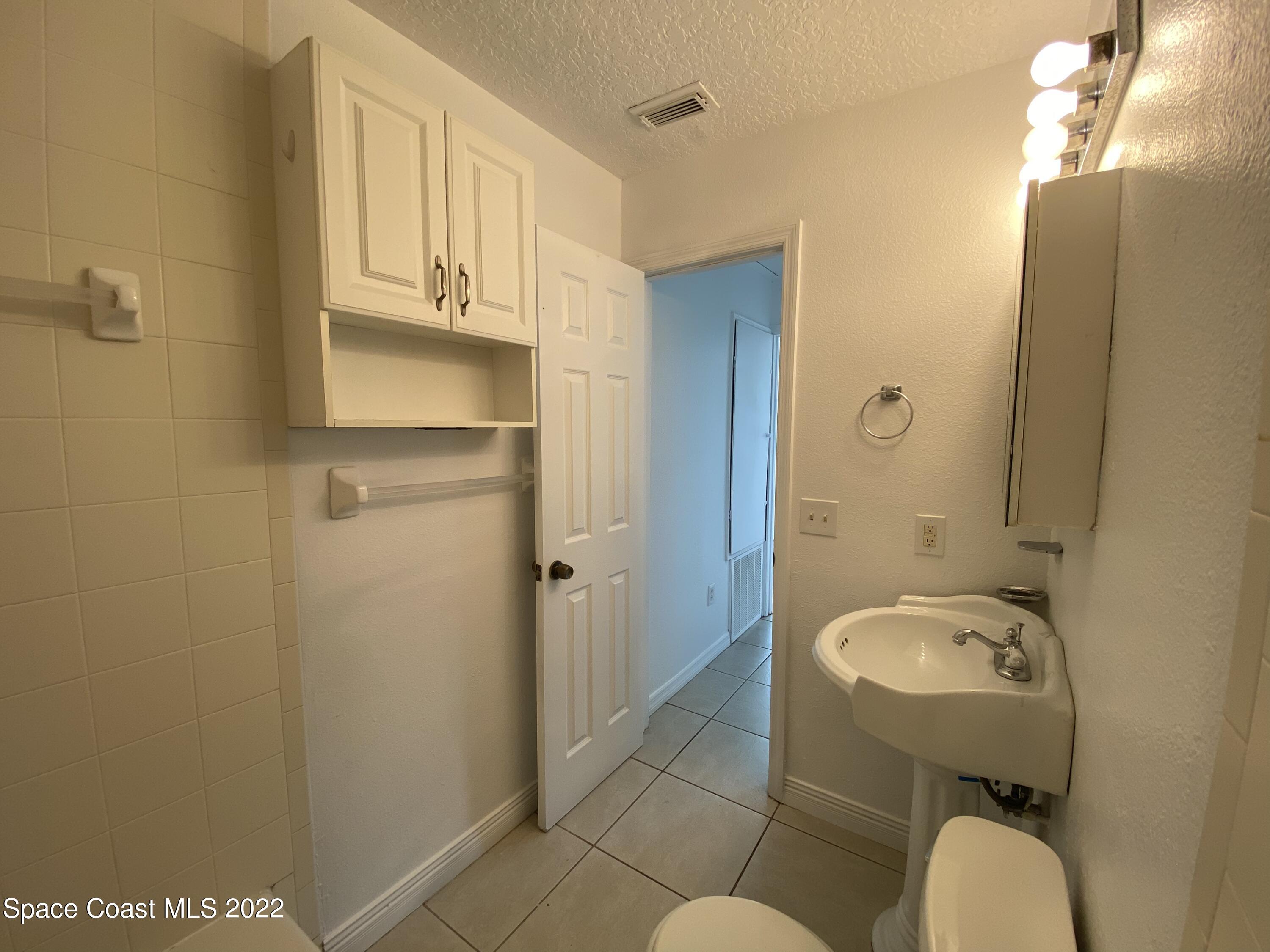 4120 Duke Street Melbourne, FL 32901 - Photo 13 of 49 a bathroom with a sink and a mirror