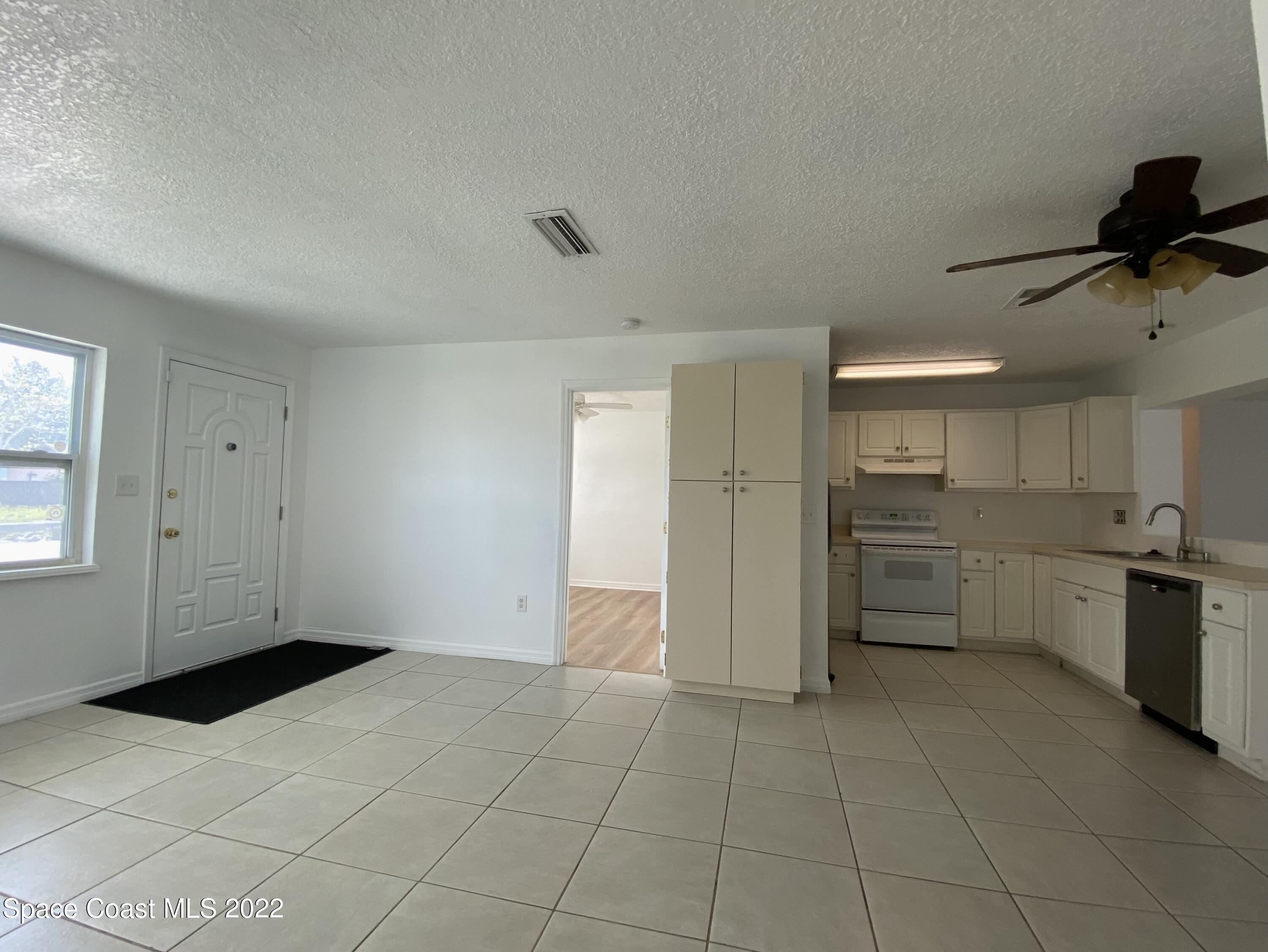 4120 Duke Street Melbourne, FL 32901 - Photo 14 of 49 a view of a kitchen with a sink and dishwasher cabinets