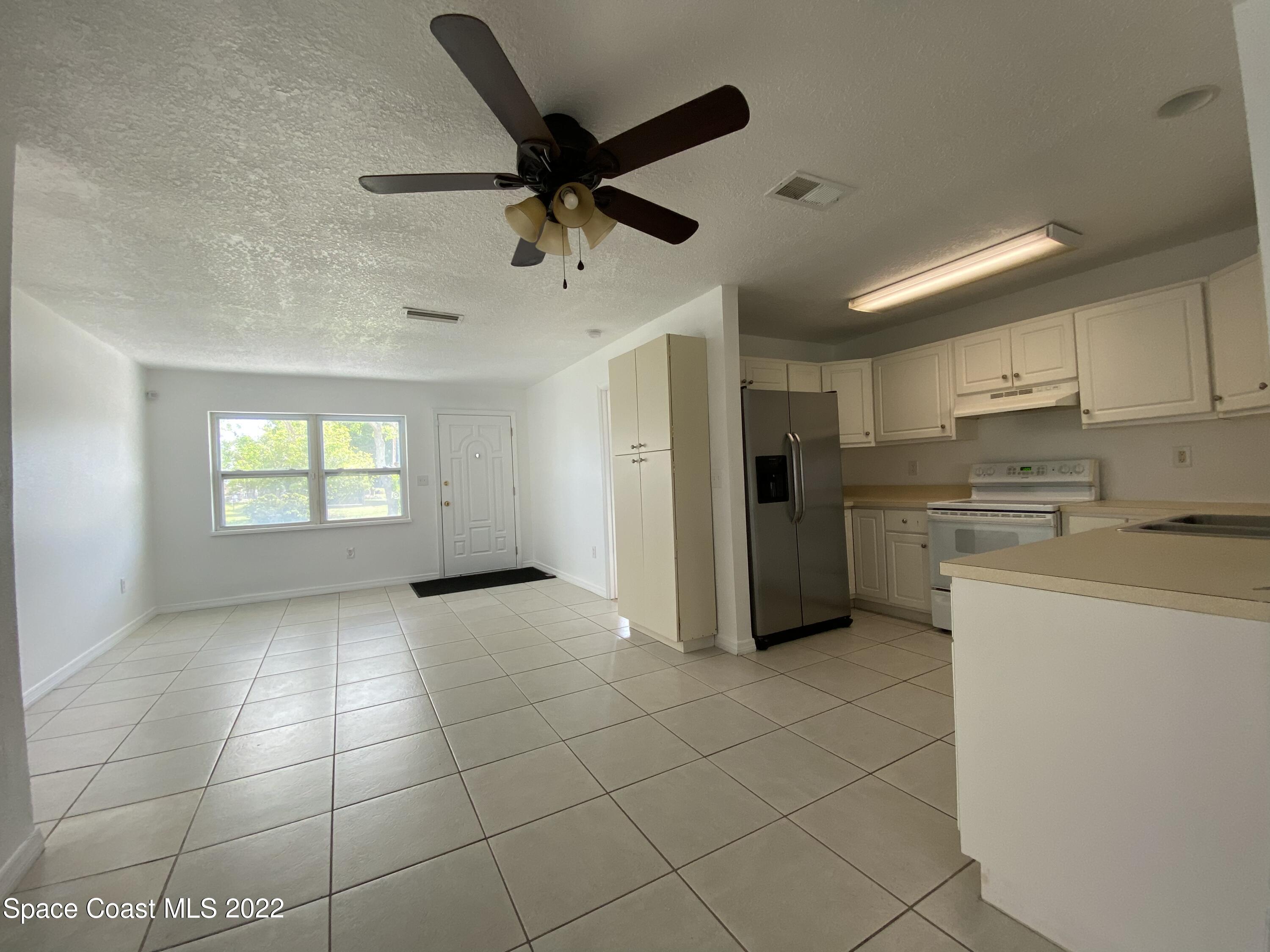 4120 Duke Street Melbourne, FL 32901 - Photo 15 of 49 a kitchen with stainless steel appliances a refrigerator a sink dishwasher and a stove top oven
