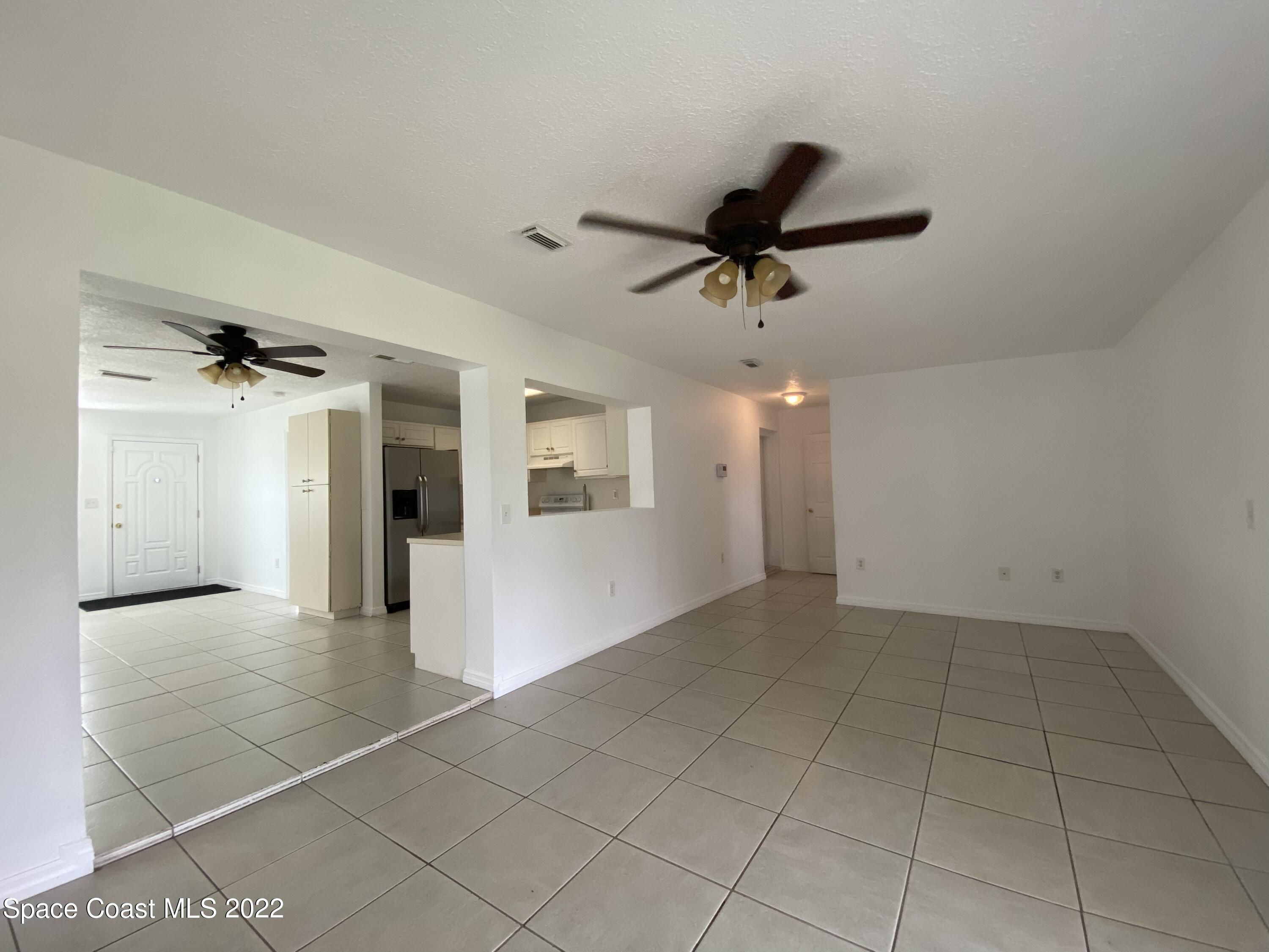 4120 Duke Street Melbourne, FL 32901 - Photo 16 of 49 a view of a livingroom with a ceiling fan and carpet