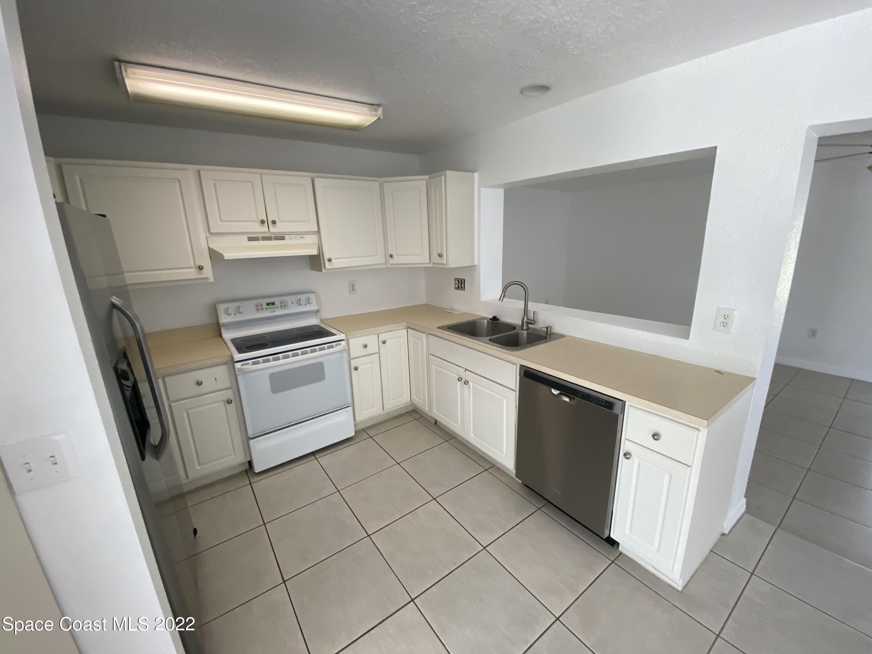 4120 Duke Street Melbourne, FL 32901 - Photo 35 of 49 a kitchen with a stove sink and cabinets