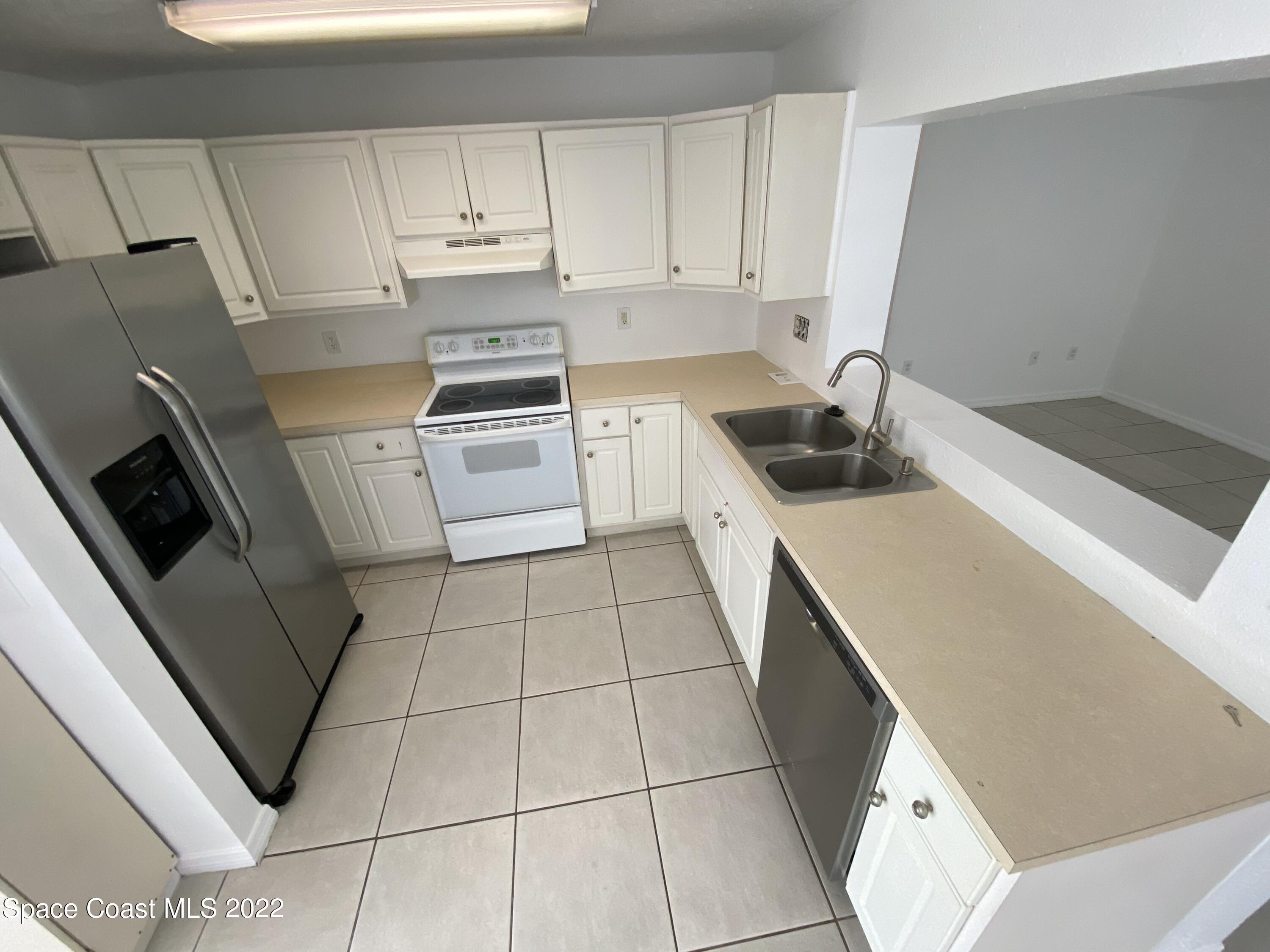 4120 Duke Street Melbourne, FL 32901 - Photo 36 of 49 a kitchen with a sink a stove top oven and cabinets