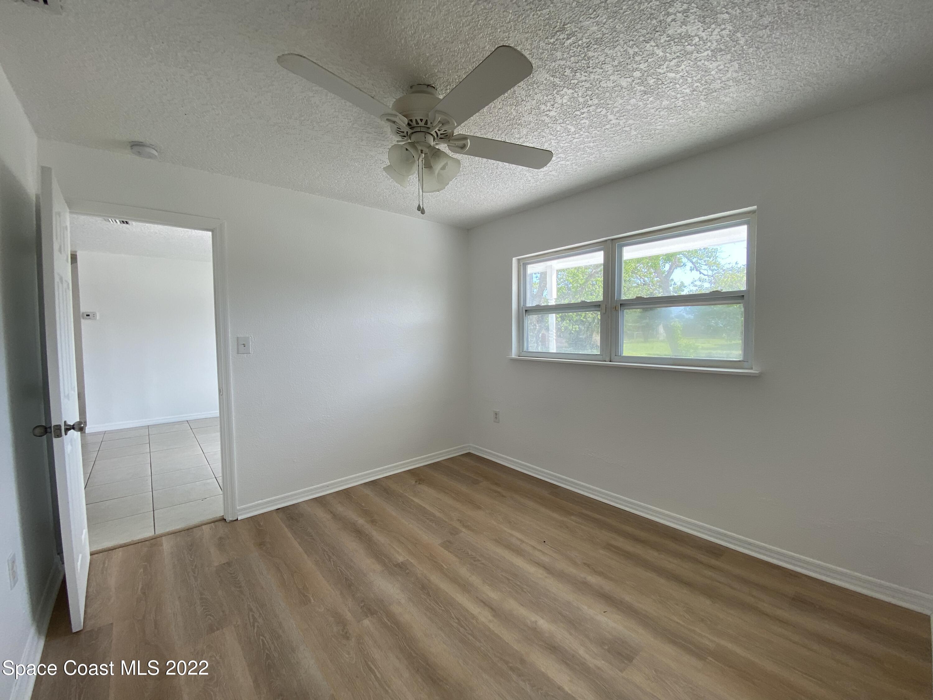 4120 Duke Street Melbourne, FL 32901 - Photo 41 of 49 wooden floor in an empty room with a window