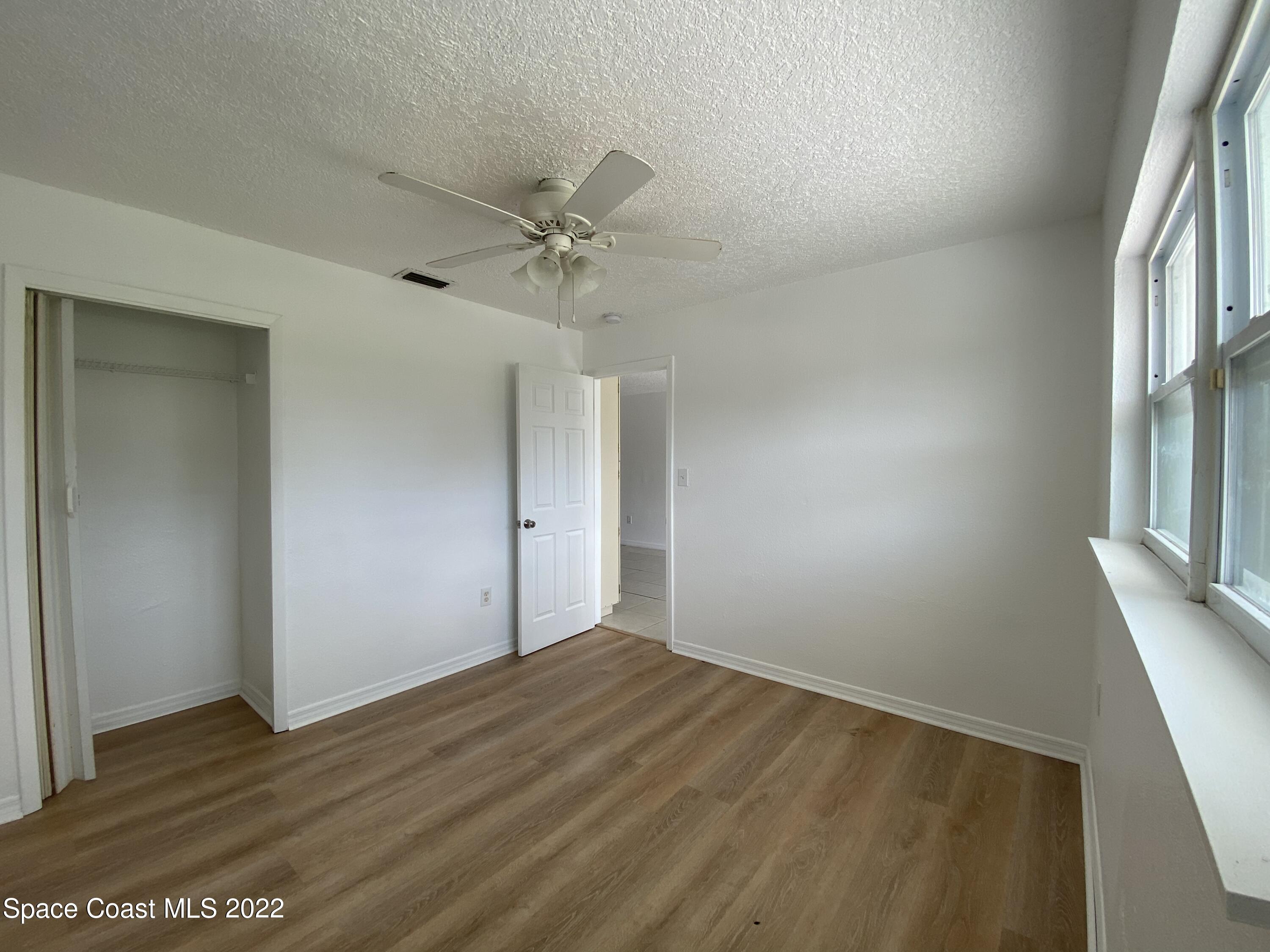 4120 Duke Street Melbourne, FL 32901 - Photo 42 of 49 a view of empty room with wooden floor and fan