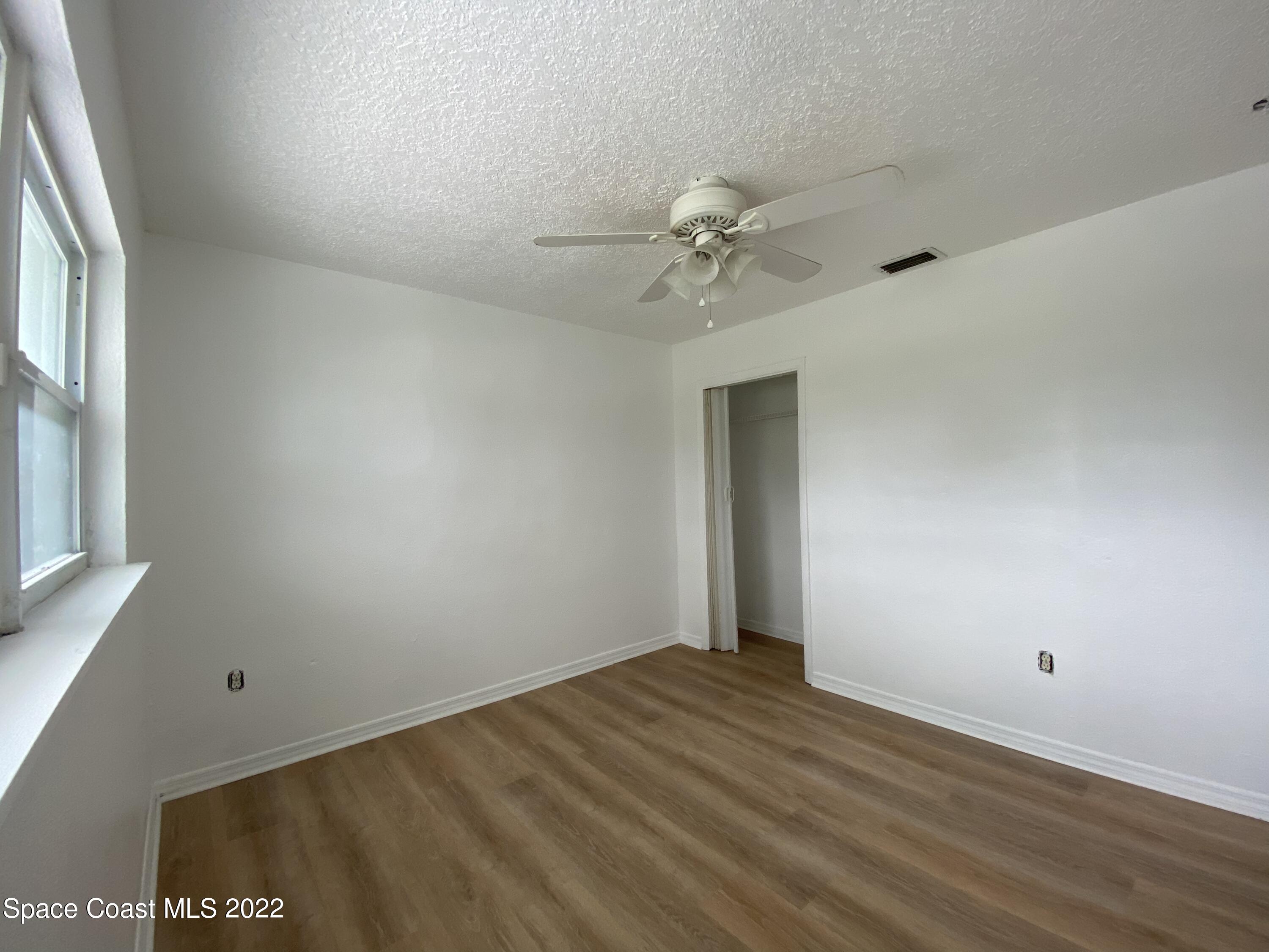 4120 Duke Street Melbourne, FL 32901 - Photo 6 of 49 a view of room with window and ceiling fan