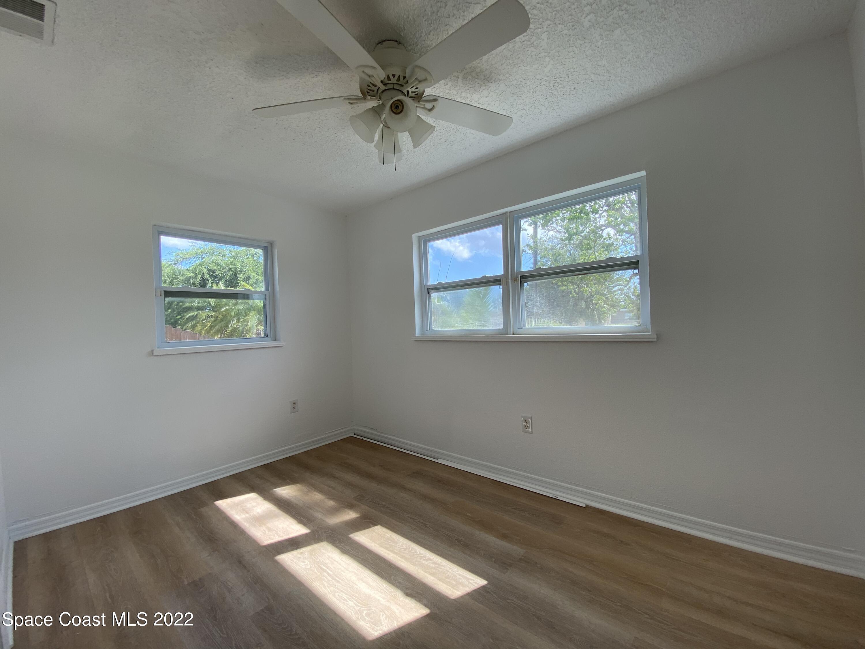 4120 Duke Street Melbourne, FL 32901 - Photo 8 of 49 an empty room with wooden floor and windows