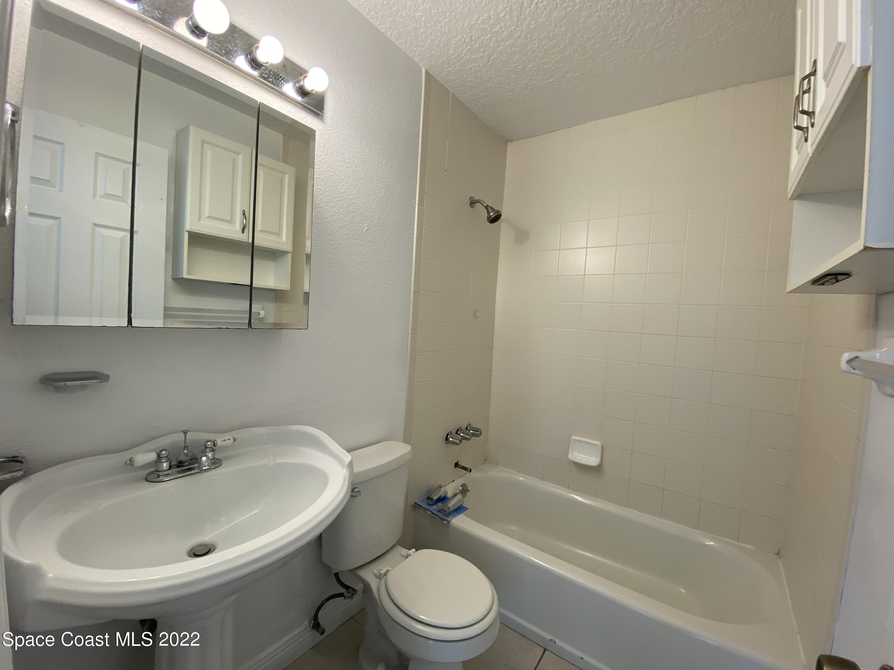 4120 Duke Street Melbourne, FL 32901 - Photo 10 of 49 a bathroom with a sink toilet and shower