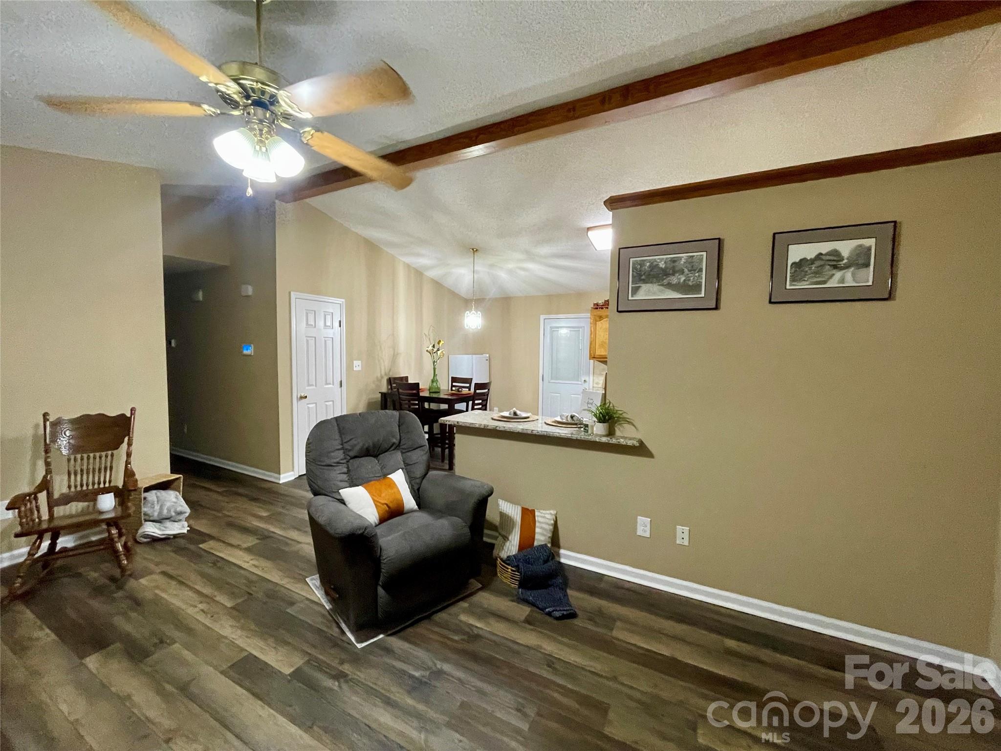 1676 Plyler Lake Road Gastonia, NC 28054 - Photo 20 of 33 a living room with furniture and a chandelier