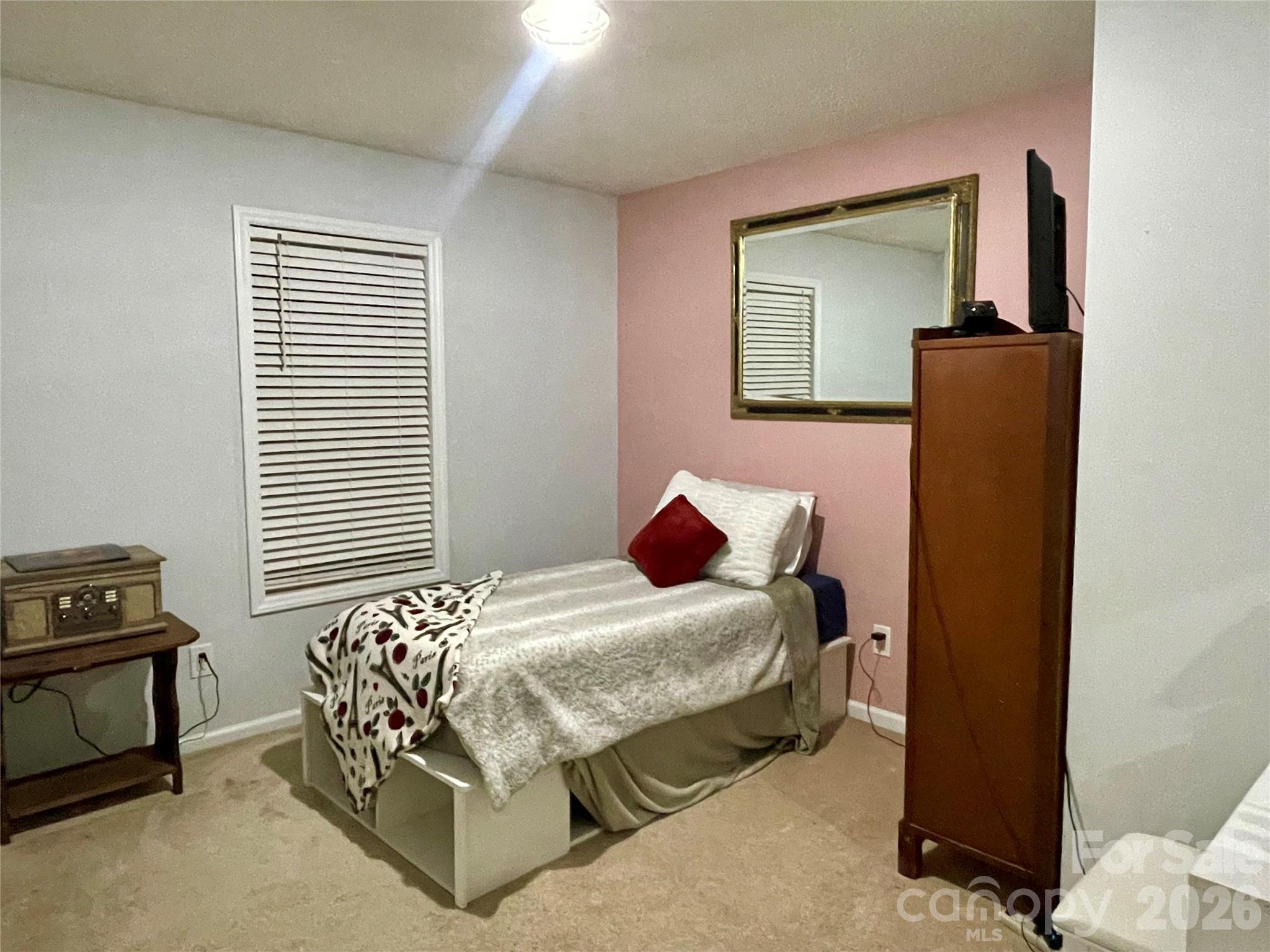 1676 Plyler Lake Road Gastonia, NC 28054 - Photo 25 of 33 a bedroom with a bed and a window