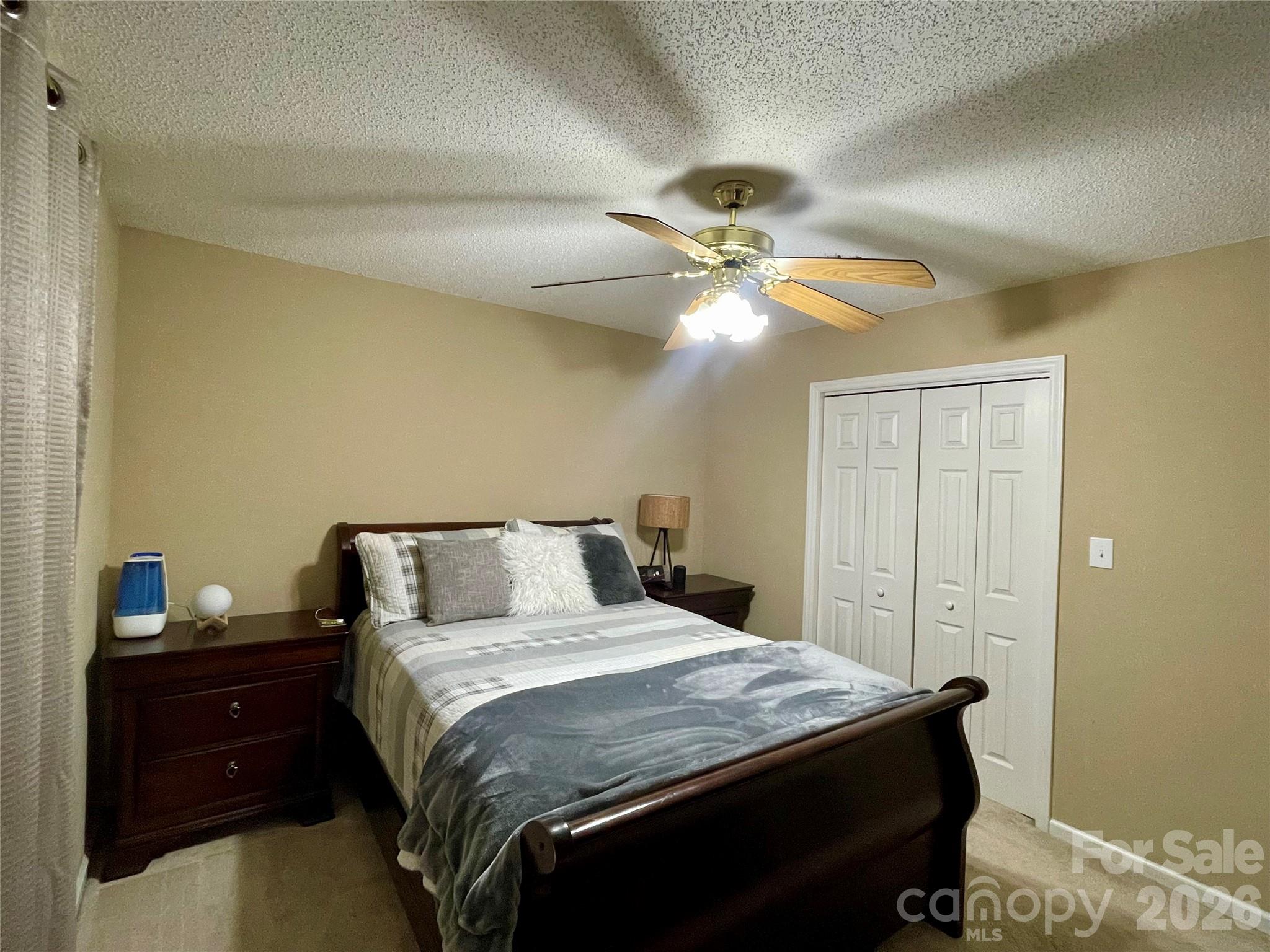 1676 Plyler Lake Road Gastonia, NC 28054 - Photo 27 of 33 a bedroom with a bed and a chandelier