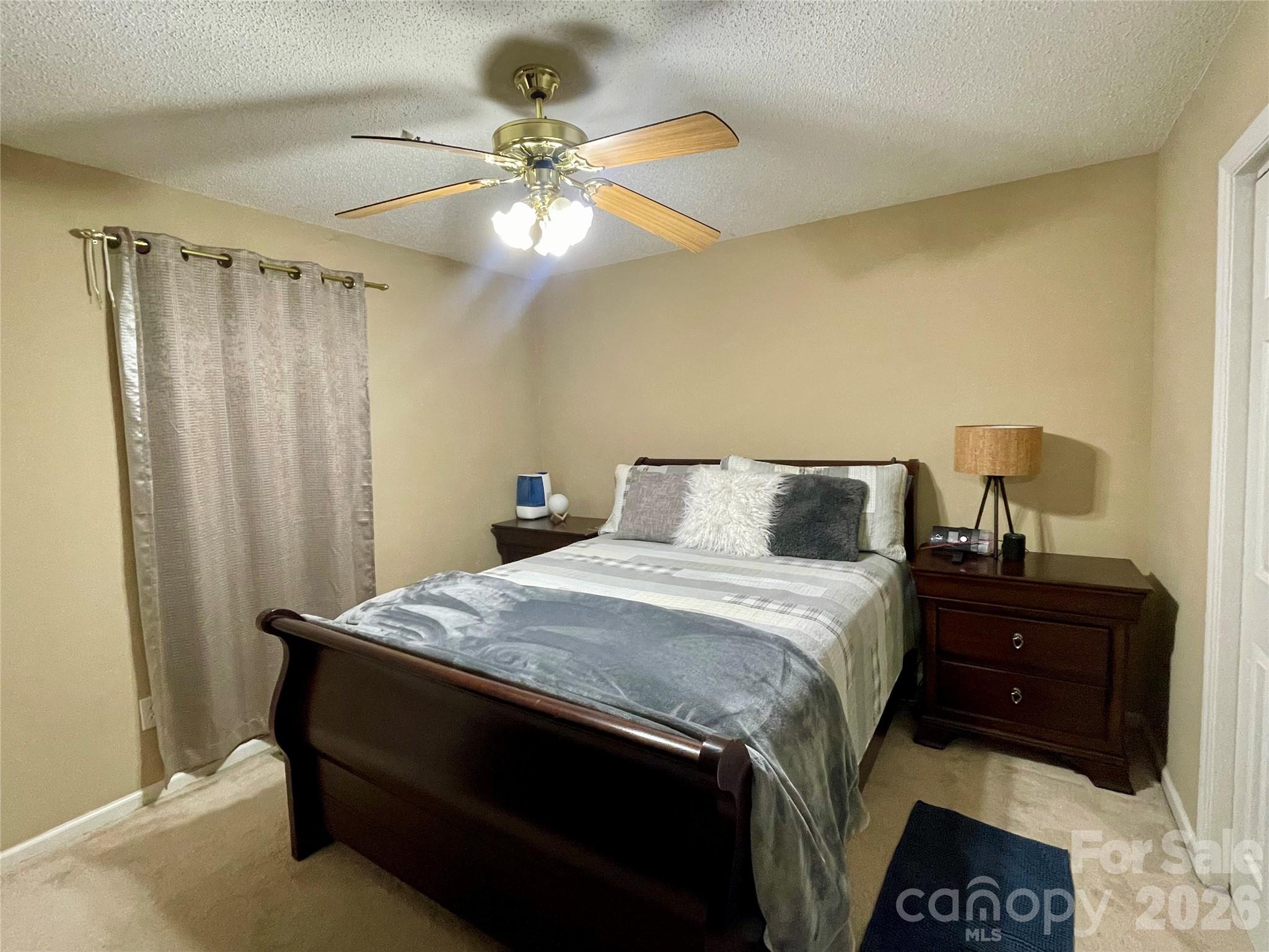 1676 Plyler Lake Road Gastonia, NC 28054 - Photo 28 of 33 a bedroom with a bed and a chandelier