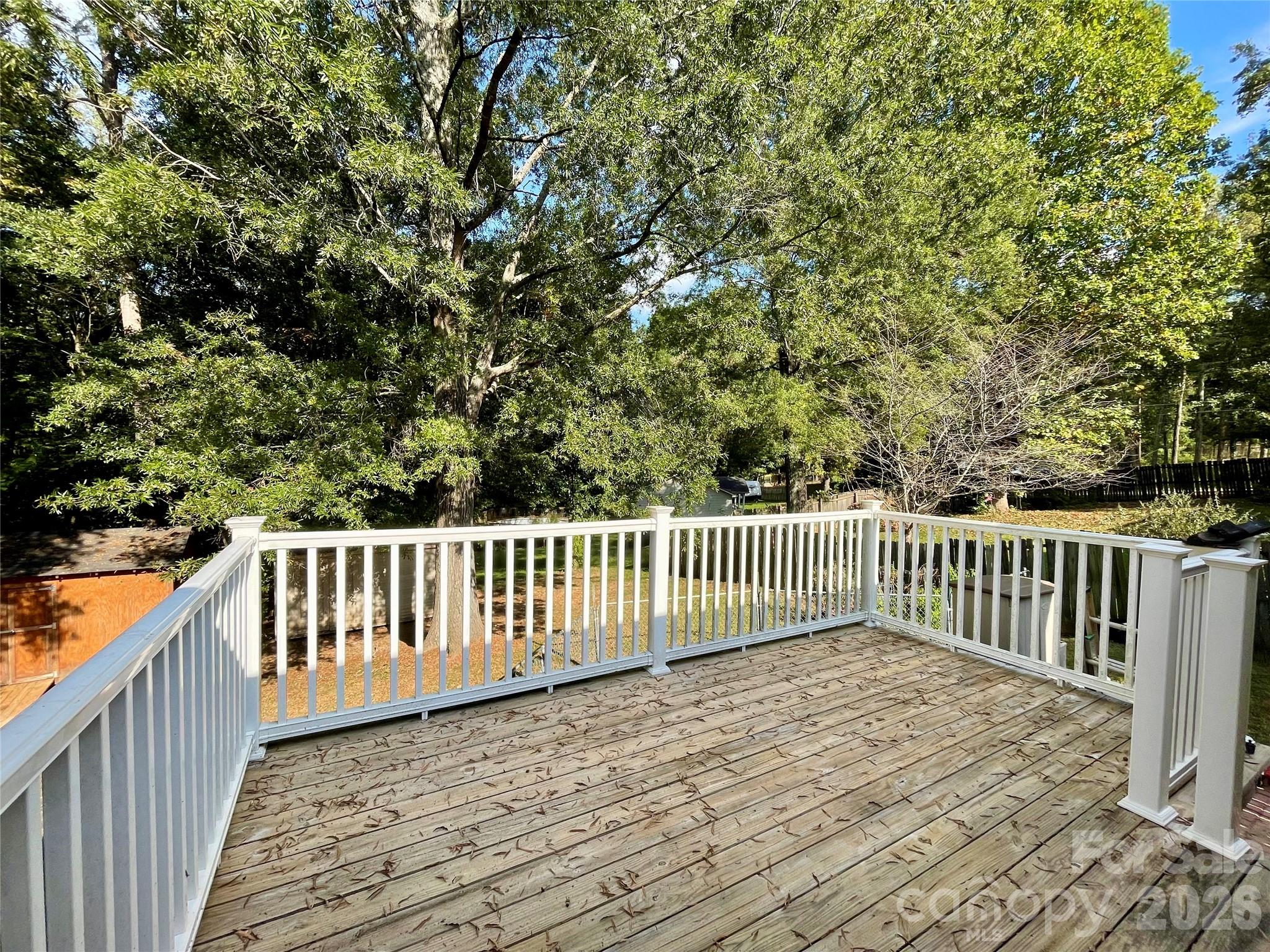 1676 Plyler Lake Road Gastonia, NC 28054 - Photo 5 of 33 a balcony with wooden floor and fence