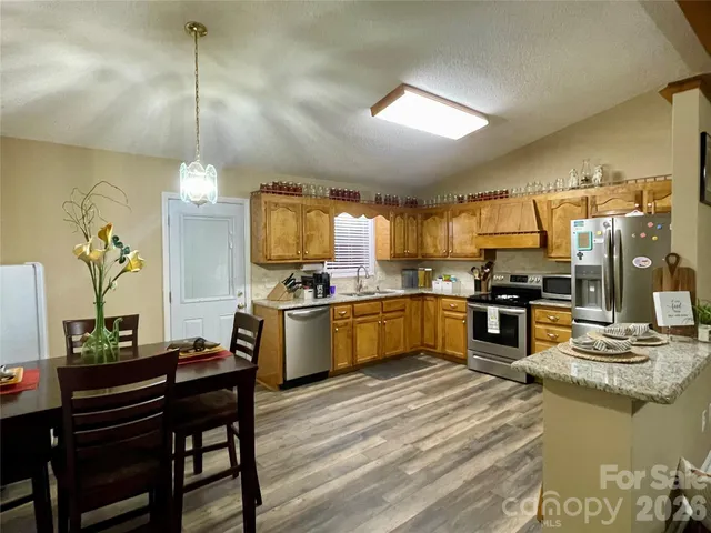 a kitchen with sink refrigerator and cabinets