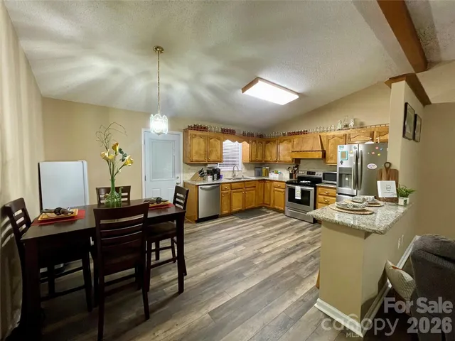 a kitchen with refrigerator cabinets and a dining table