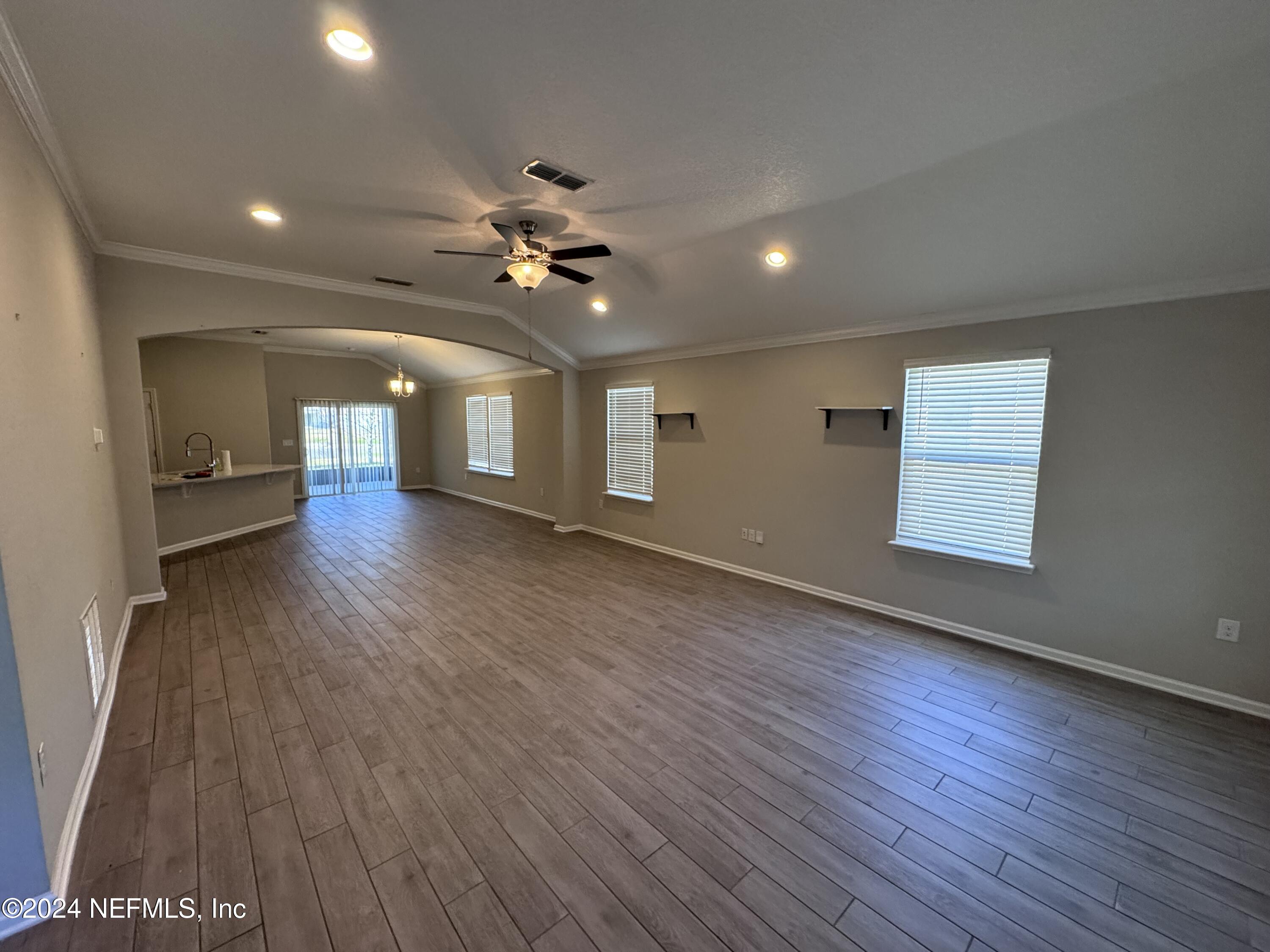 80 Balmoral Castle Drive St. Johns, FL 32259 - Photo 2 of 17 an empty room with wooden floor and windows