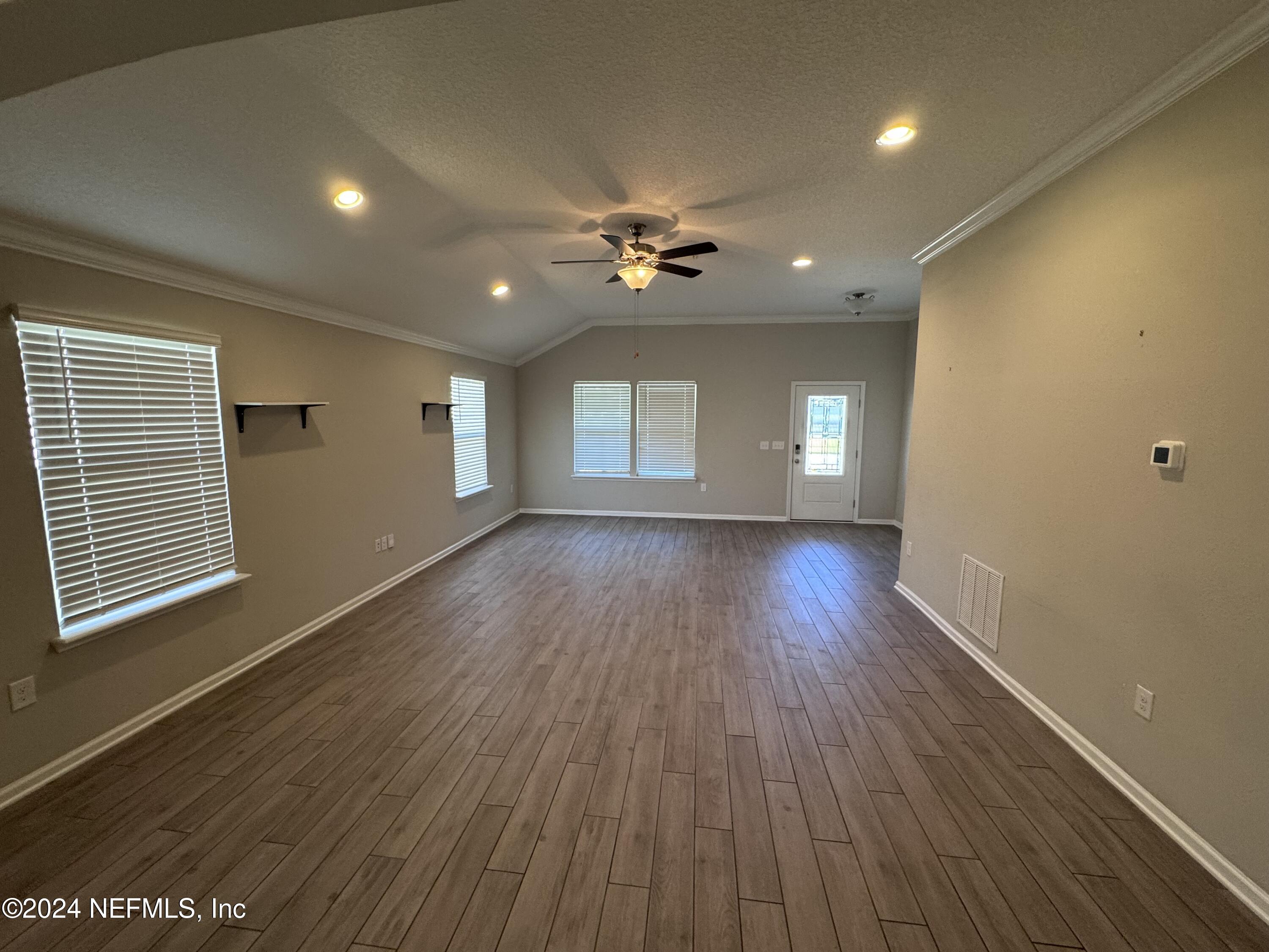 80 Balmoral Castle Drive St. Johns, FL 32259 - Photo 3 of 17 a view of an empty room with wooden floor and a window