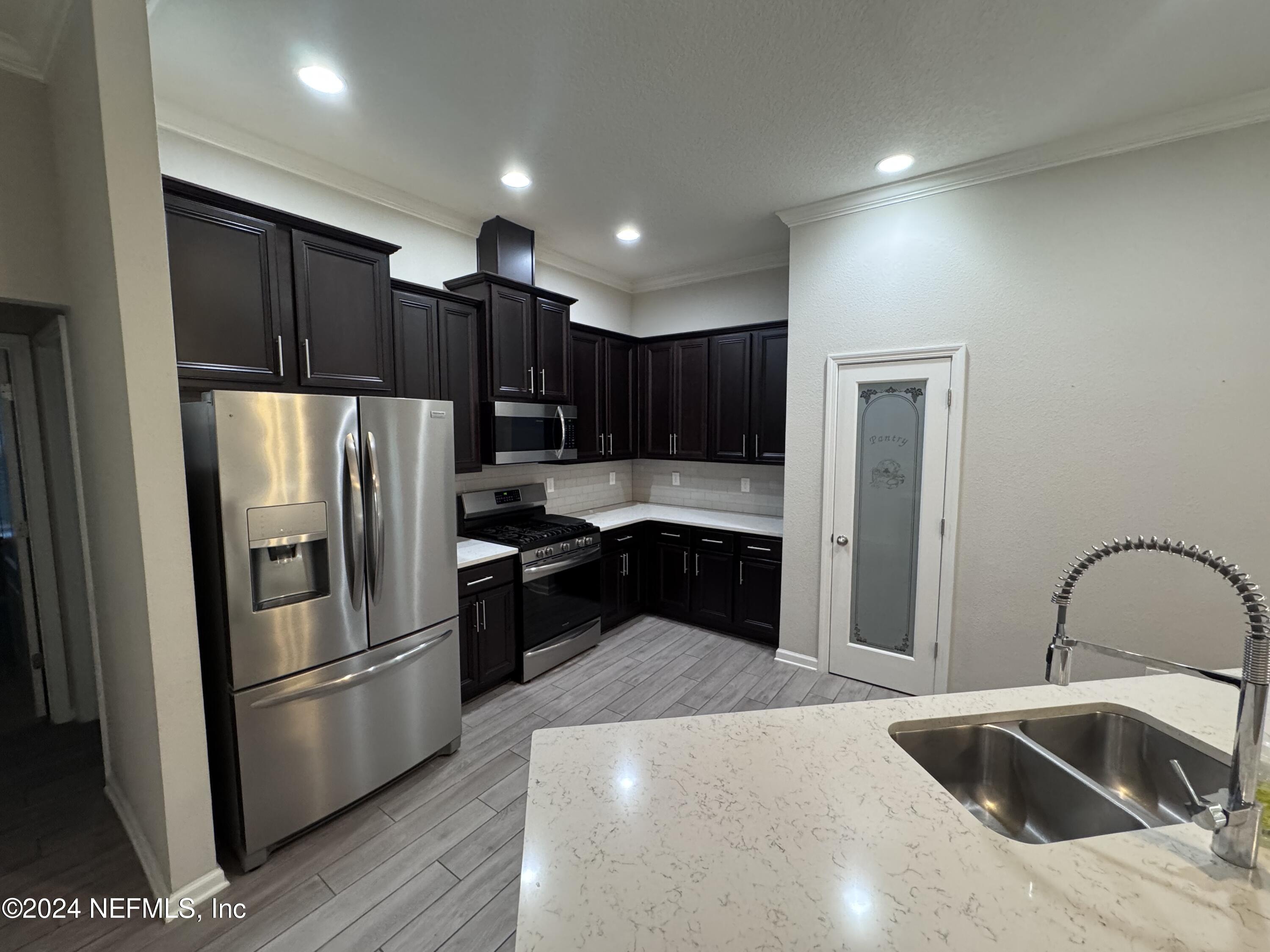 80 Balmoral Castle Drive St. Johns, FL 32259 - Photo 5 of 17 a kitchen with a refrigerator sink and cabinets