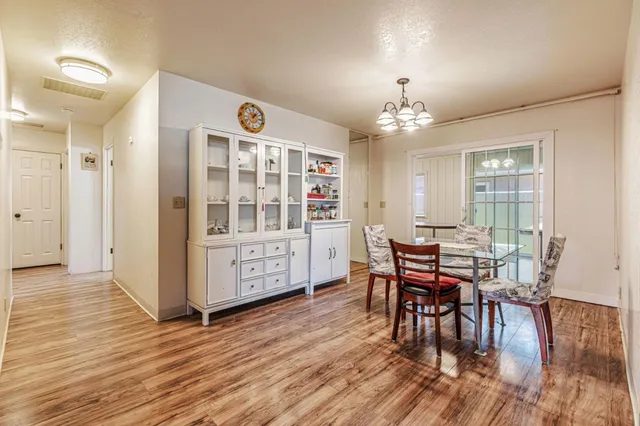 a view of a a dining room with furniture window and wooden floor