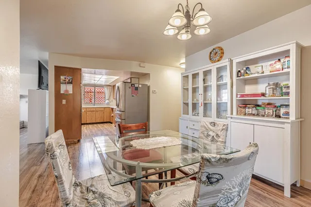 a view of a dining room with furniture and chandelier