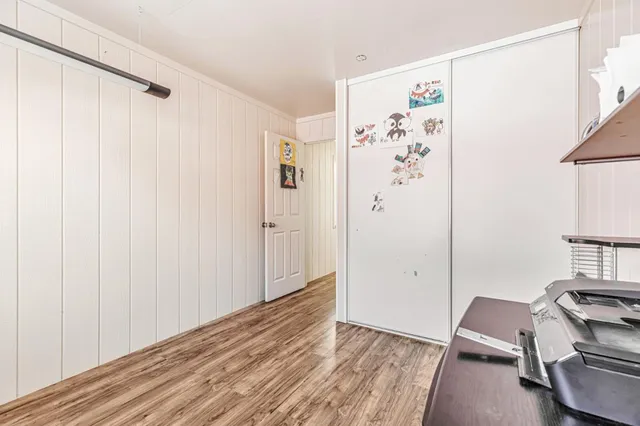 a view of a room with wooden floor and closet