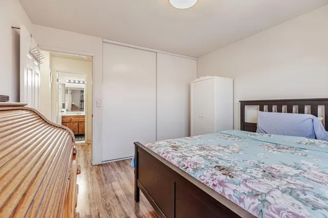 a bedroom with a bed and wooden floor