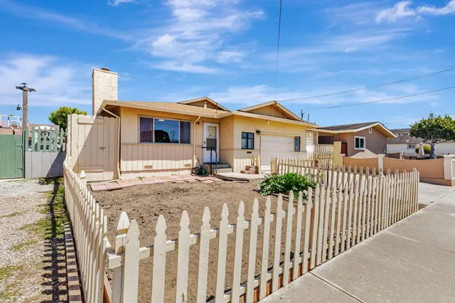 a front view of a house with wooden fence