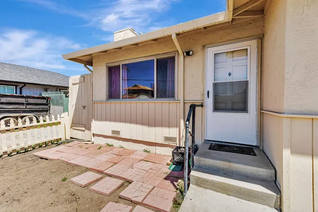 a front view of a house with a bench