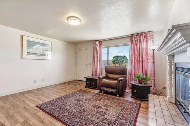 a living room with furniture rug and a window