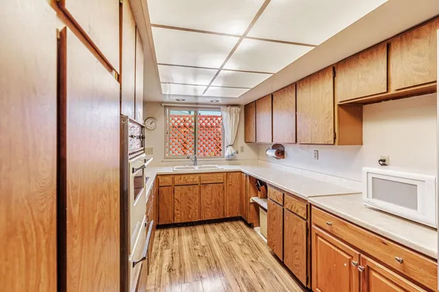 a kitchen with stainless steel appliances granite countertop a sink a stove cabinets counter space and cabinets