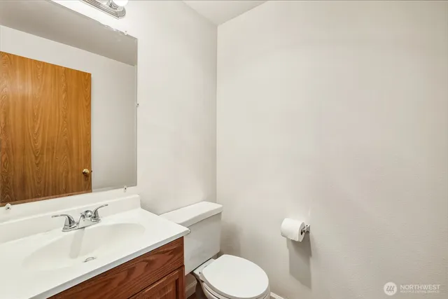 a bathroom with a sink a toilet and mirror