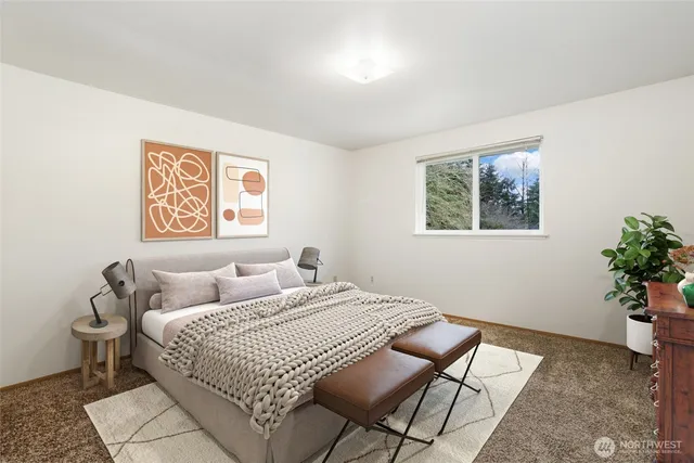 a bedroom with a bed and a potted plant