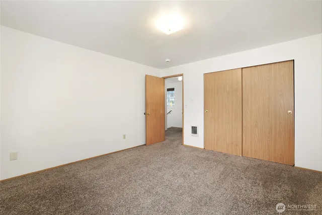 an empty room with closet area