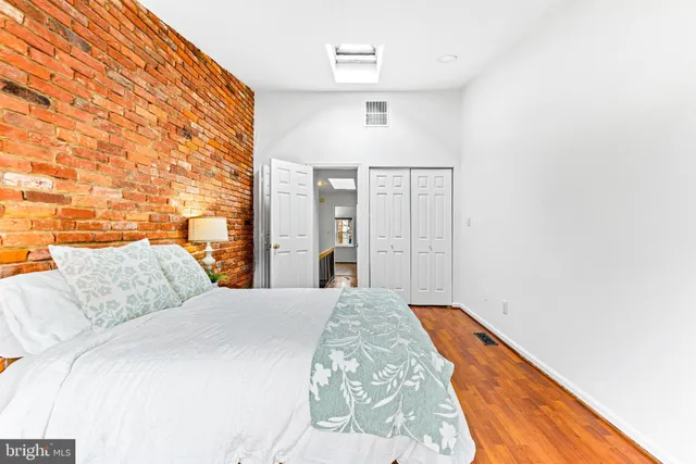 a bedroom with a bed and a night stand