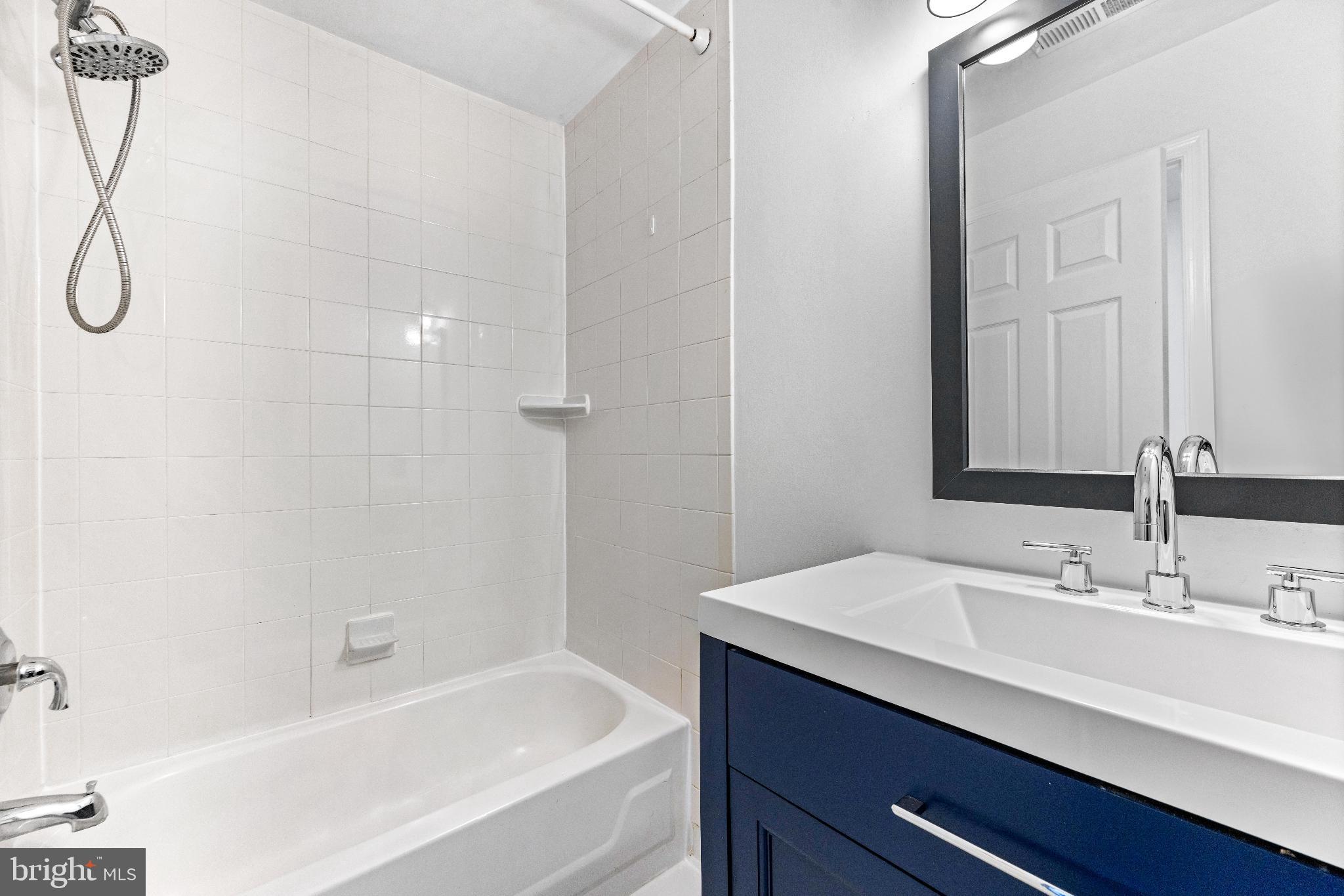 1046 Patapsco Street Baltimore, MD 21230 - Photo 15 of 19 a bathroom with a sink and a mirror