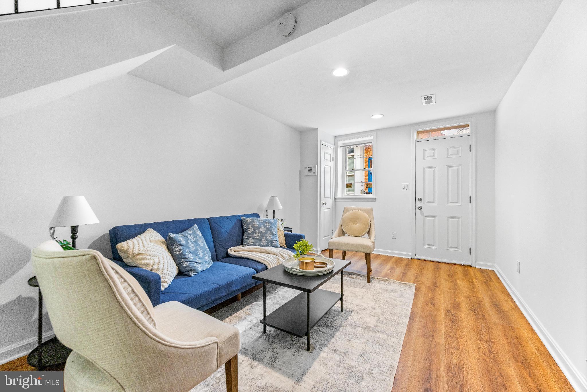 1046 Patapsco Street Baltimore, MD 21230 - Photo 4 of 19 a living room with furniture and a wooden floor