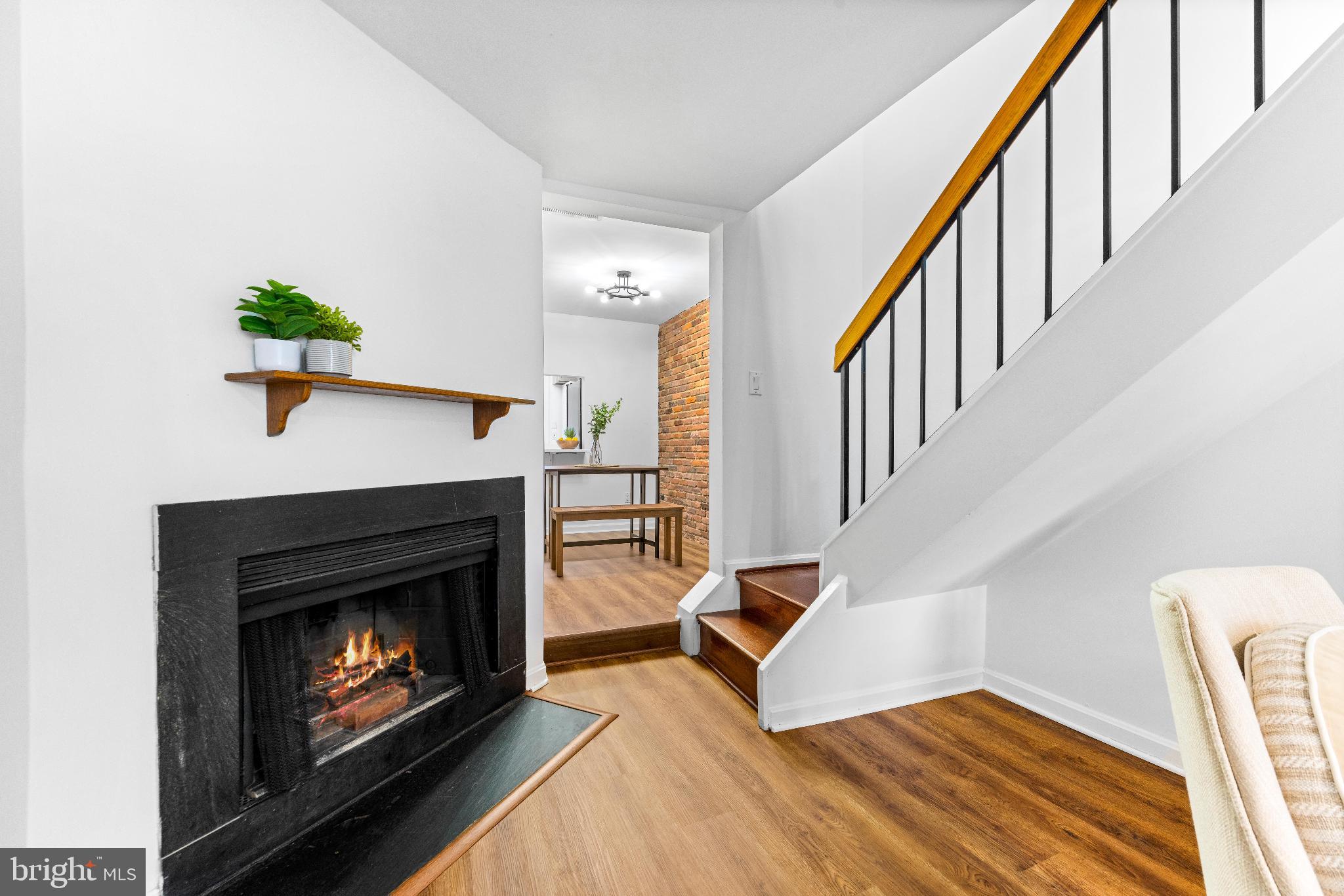 1046 Patapsco Street Baltimore, MD 21230 - Photo 5 of 19 a living room with wooden floor and a fireplace