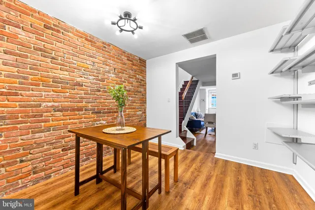 a view of a room with furniture and wooden floor