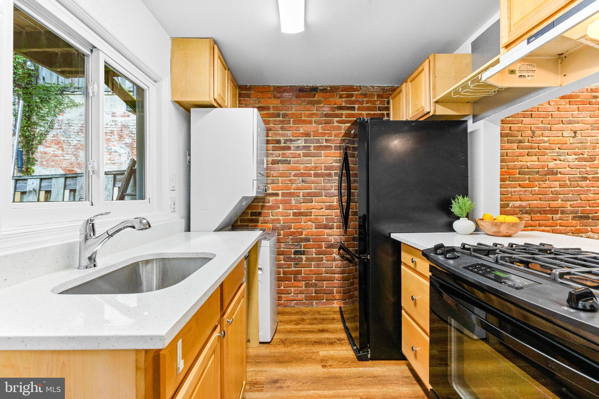 1046 Patapsco Street Baltimore, MD 21230 - Photo 8 of 19 a kitchen with stainless steel appliances granite countertop a sink and a stove