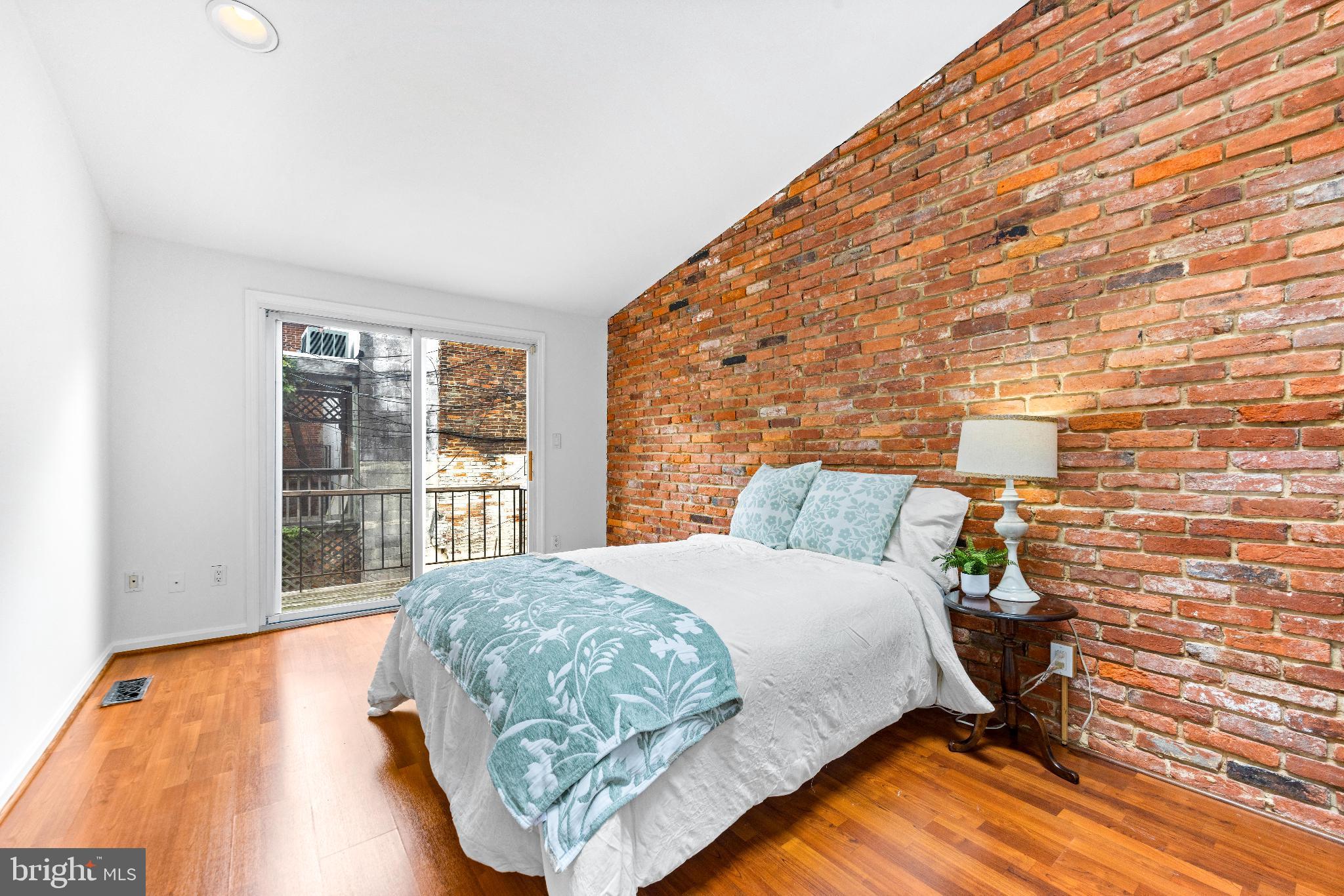 1046 Patapsco Street Baltimore, MD 21230 - Photo 10 of 19 a bedroom with a bed and wooden floor