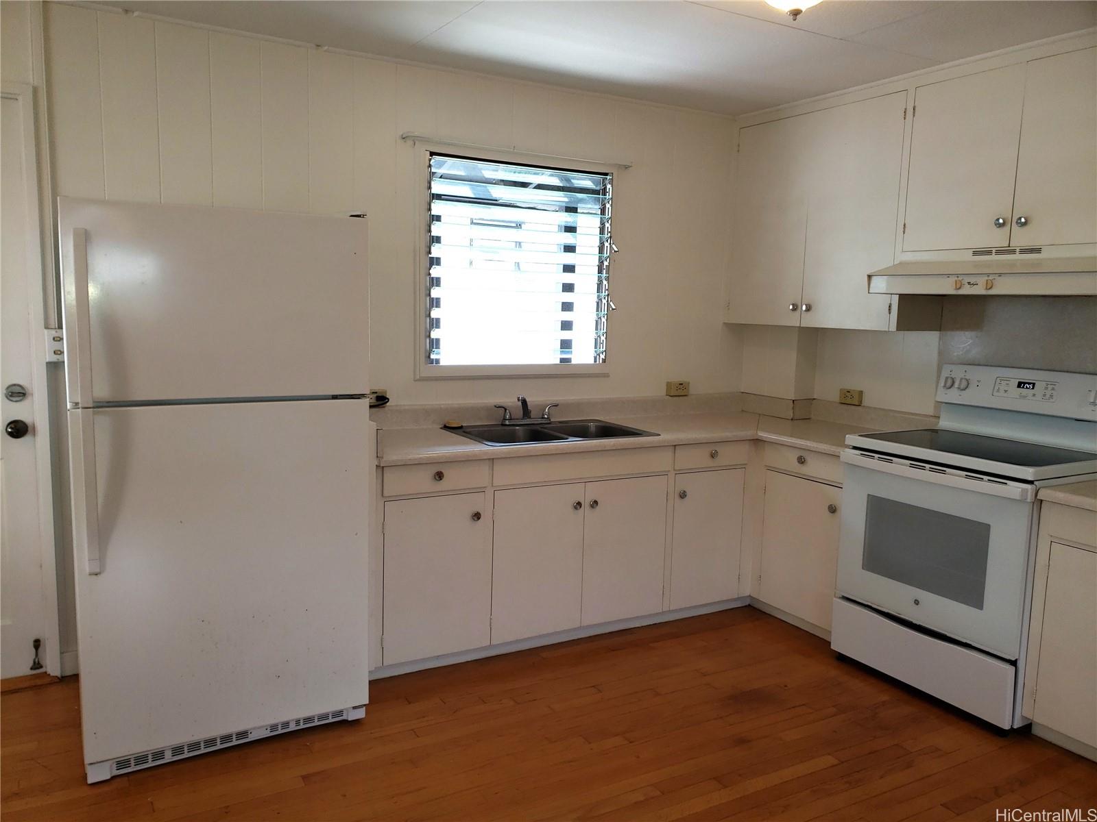 2313 Star Road, Unit A Honolulu, HI 96813 - Photo 3 of 21 a kitchen with granite countertop white cabinets and white appliances